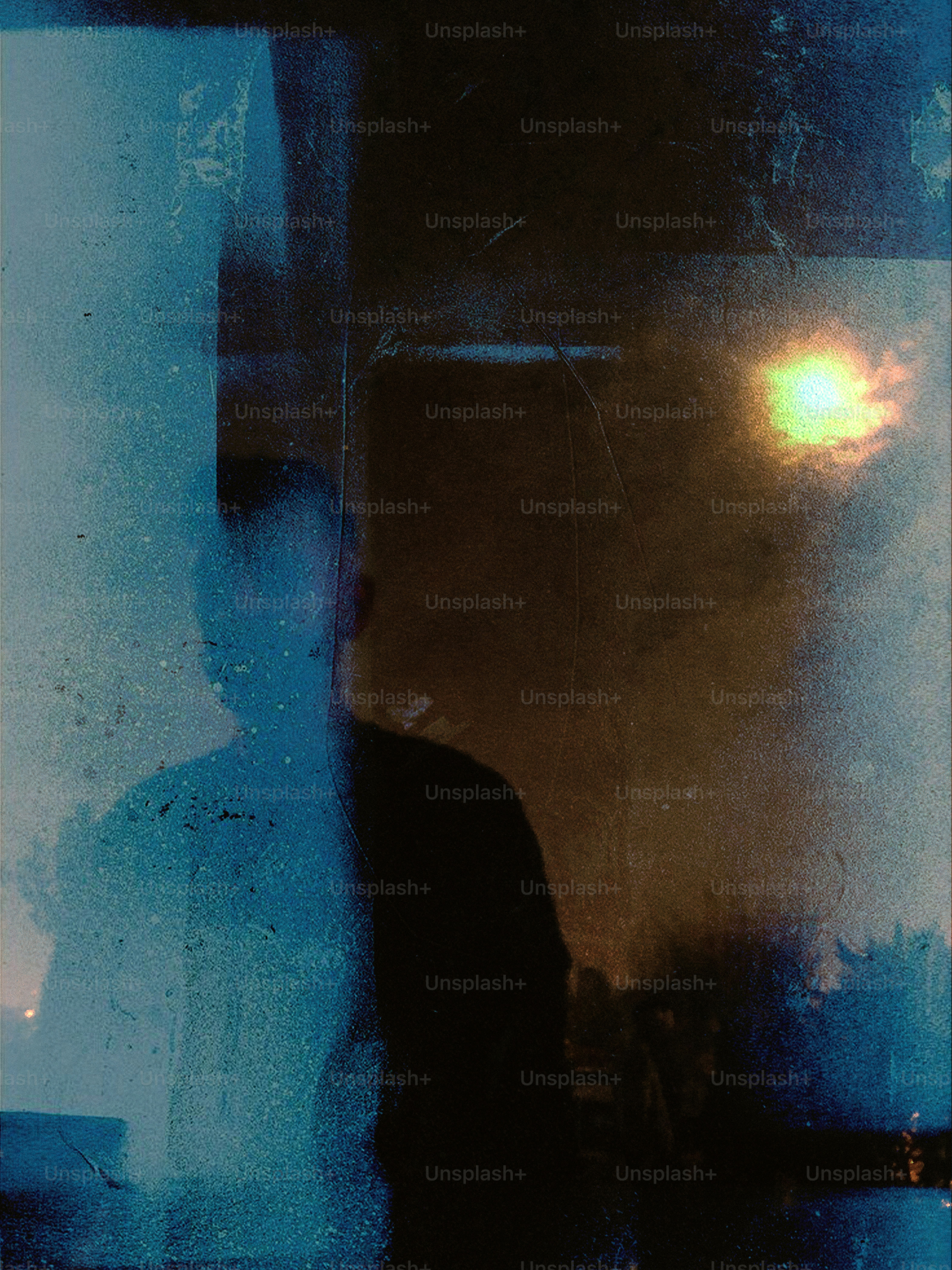 Person in silhouette against textured background - Photo on Unsplash+