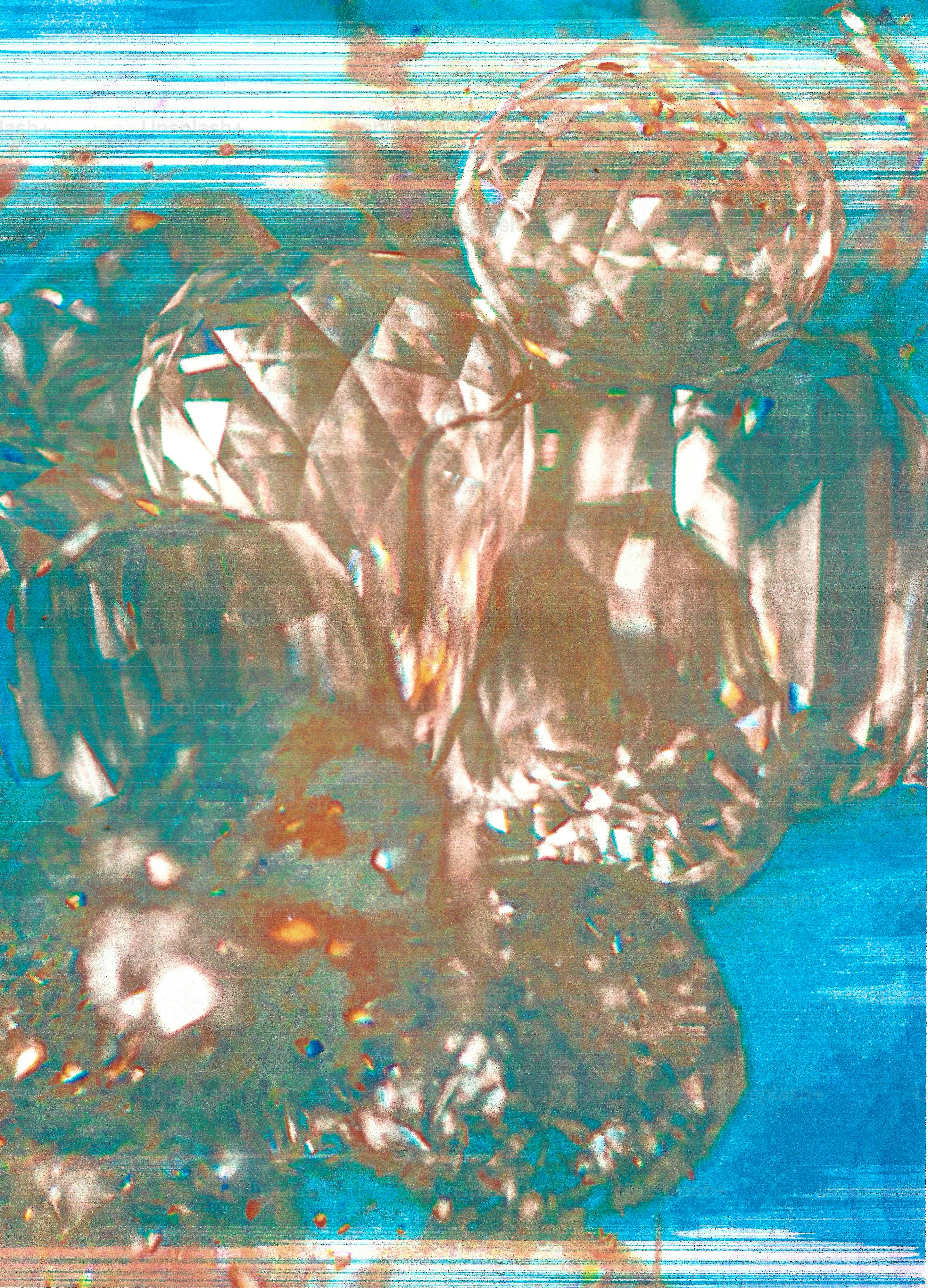 Faceted crystal spheres reflecting light against a textured blue and white background