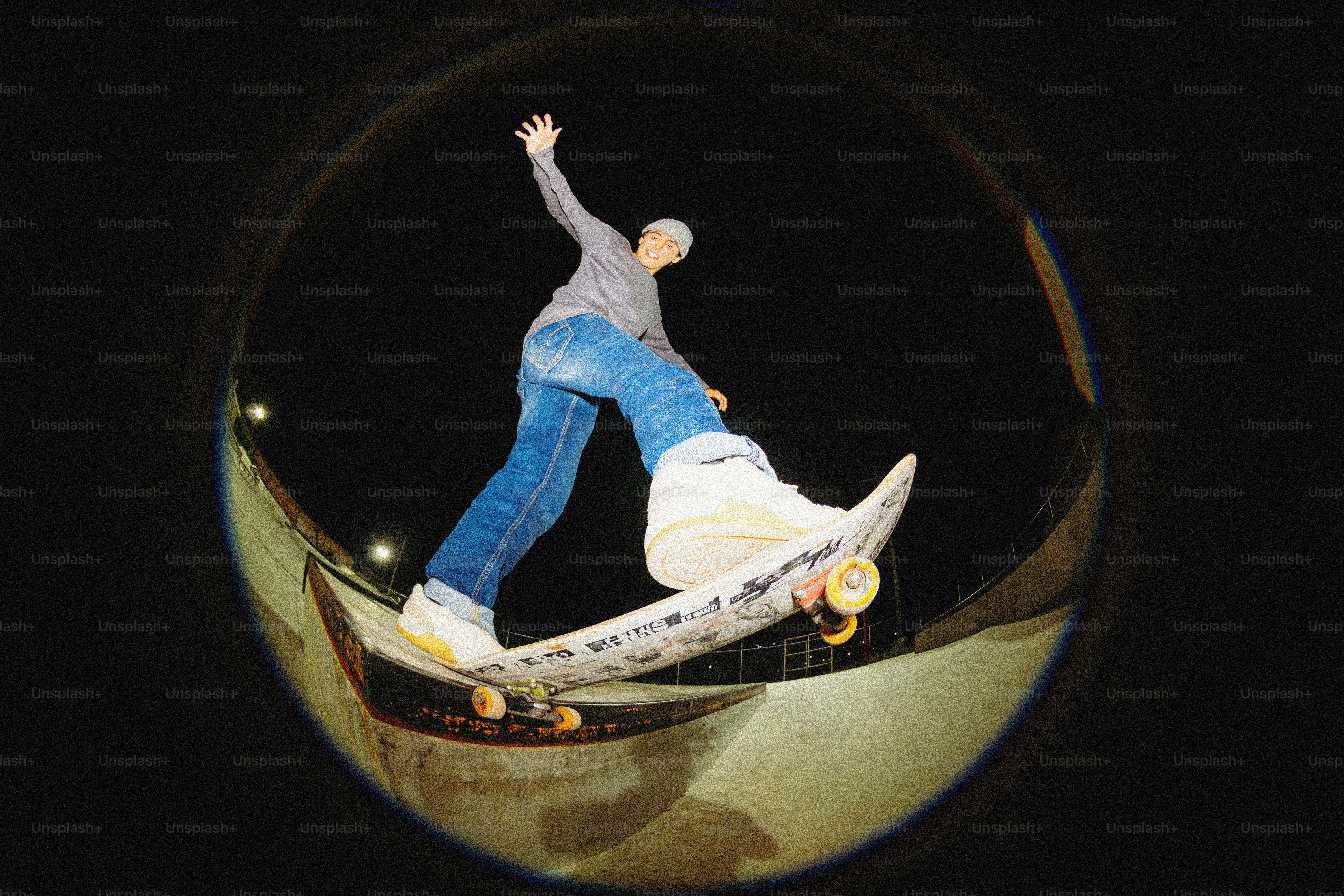 Person riding skateboard on night ramp - Photo on Unsplash+