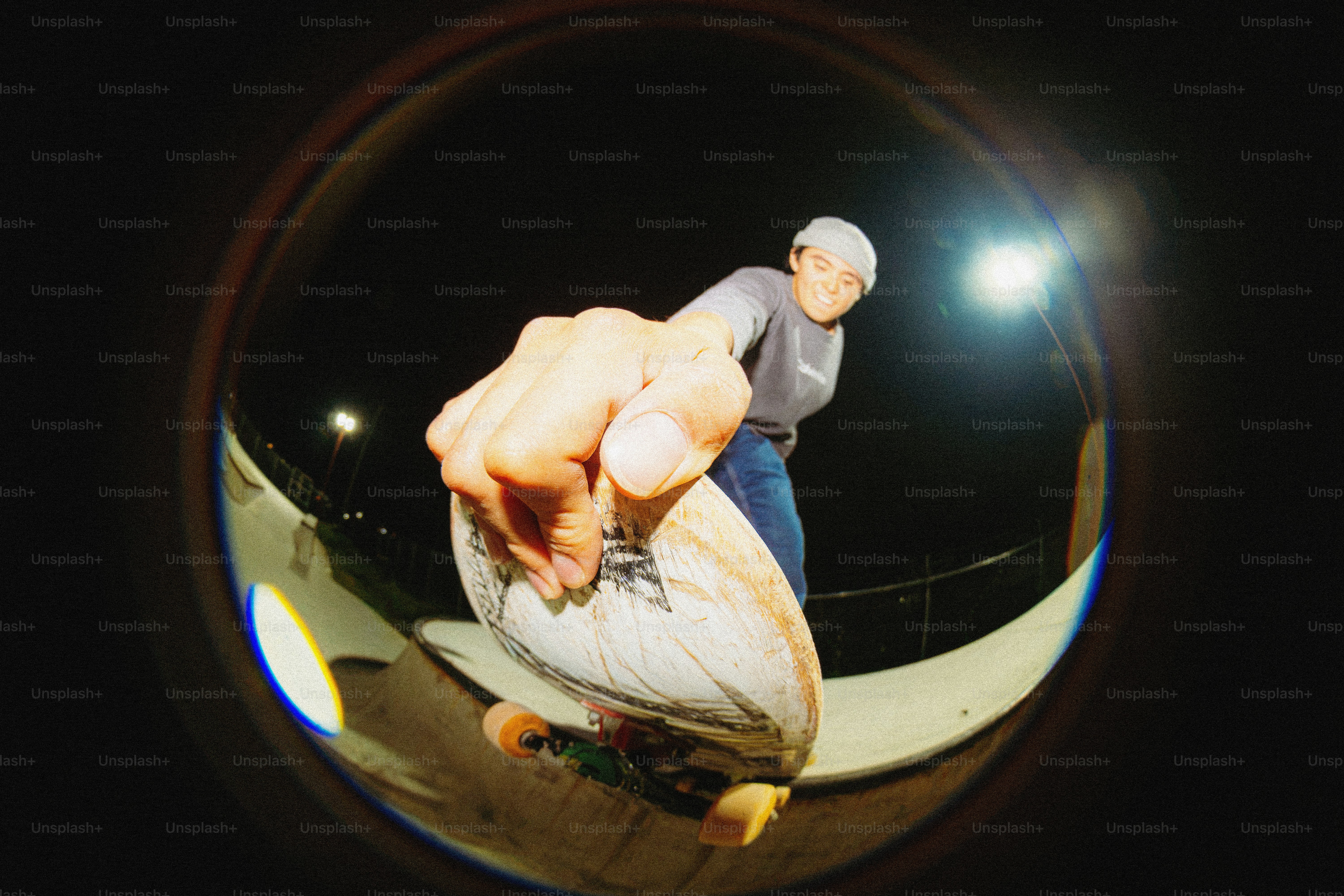 Person riding skateboard on night ramp - Photo on Unsplash+
