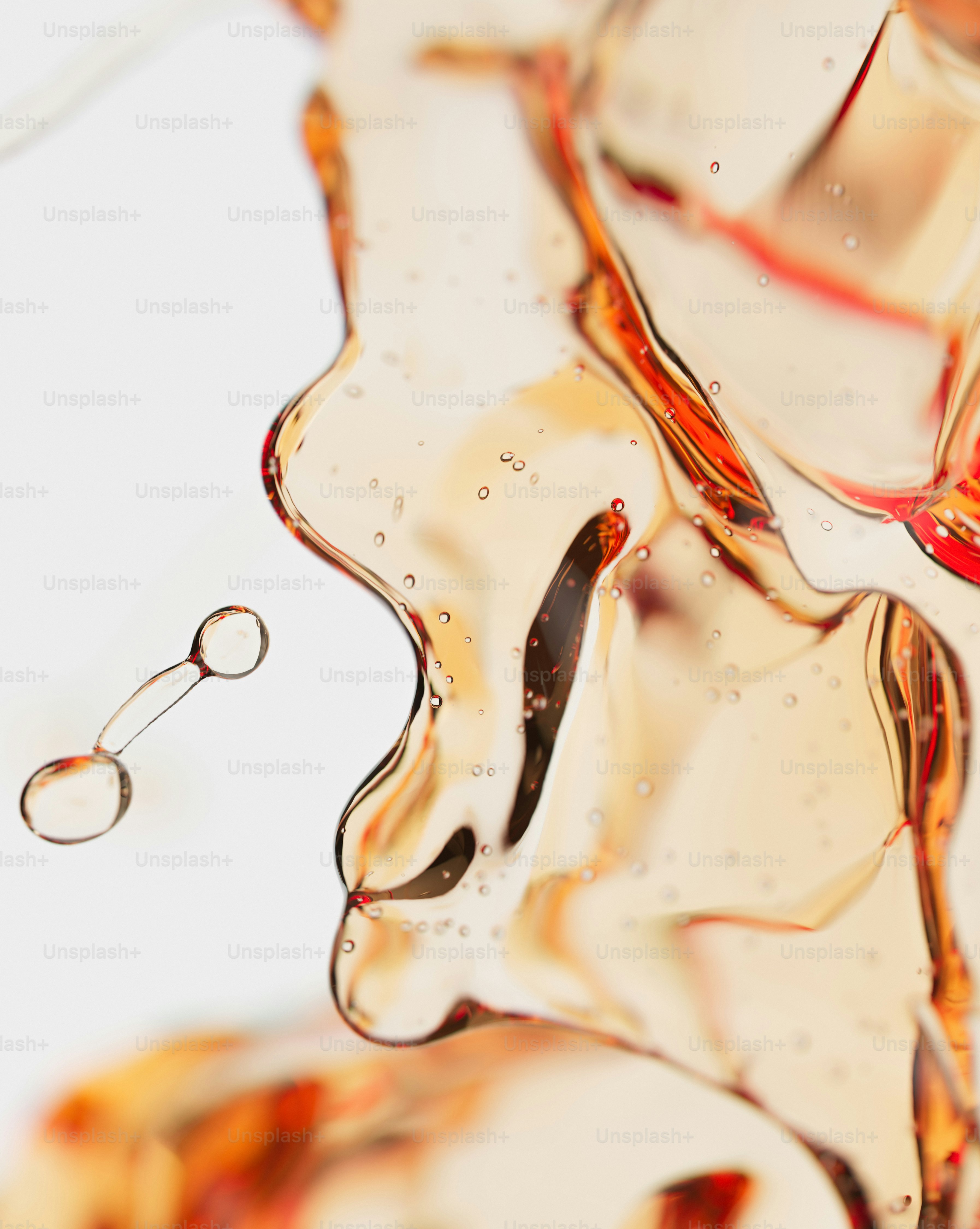 A 3D render of amber liquid splashing with small bubbles against a white background