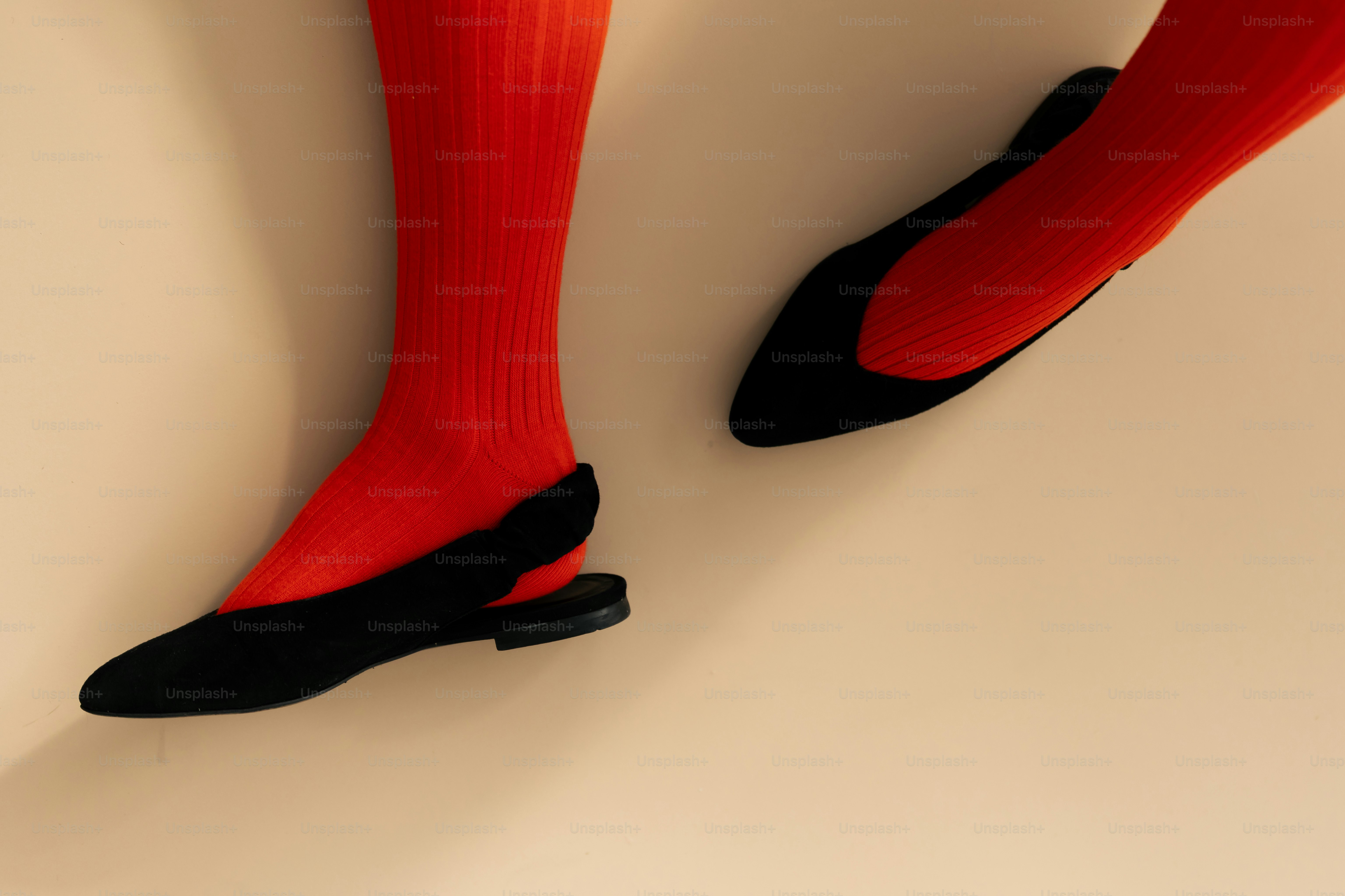 Person with red landline telephone - Photo on Unsplash+