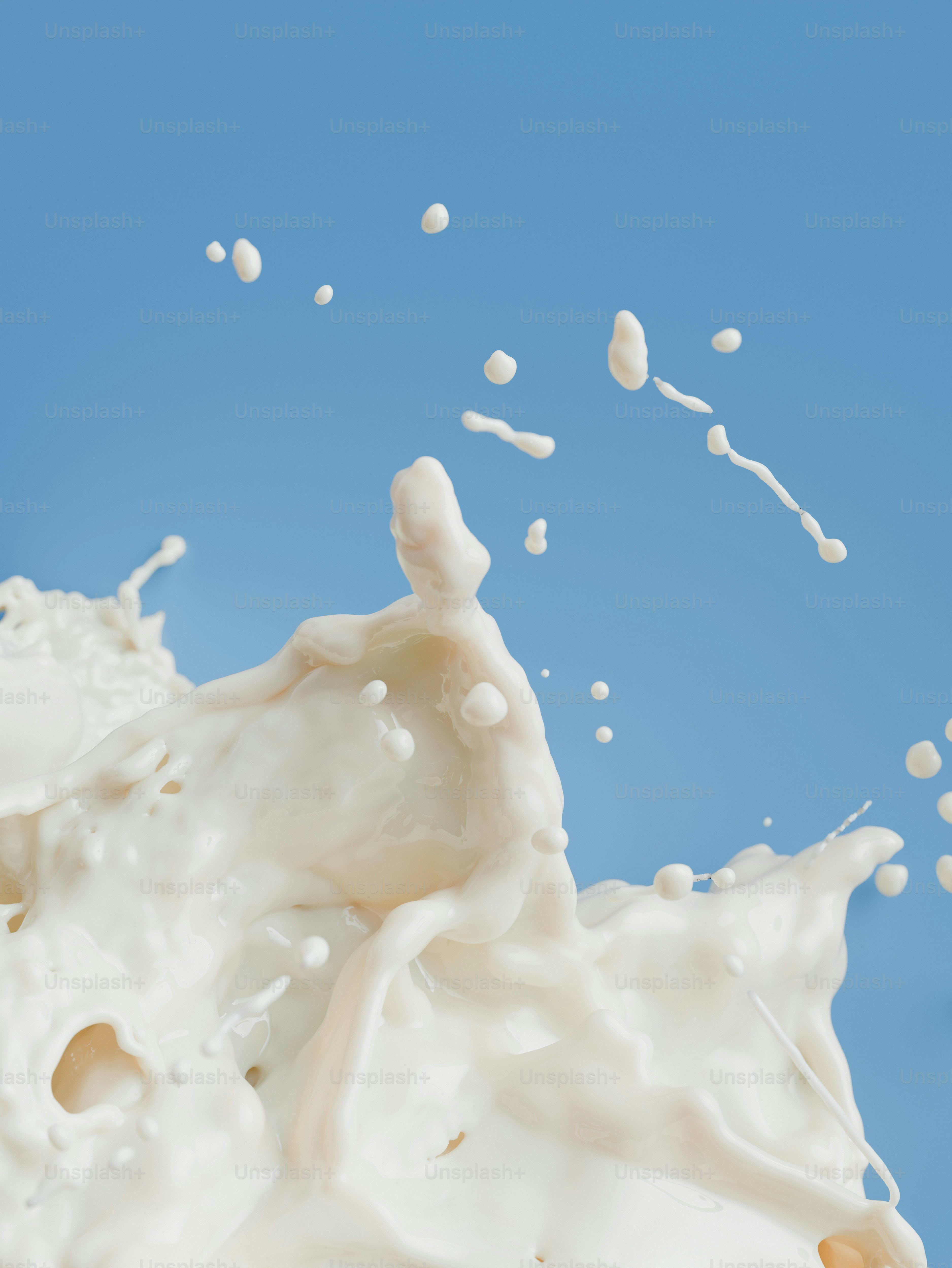 A splash of white milk against a solid blue background