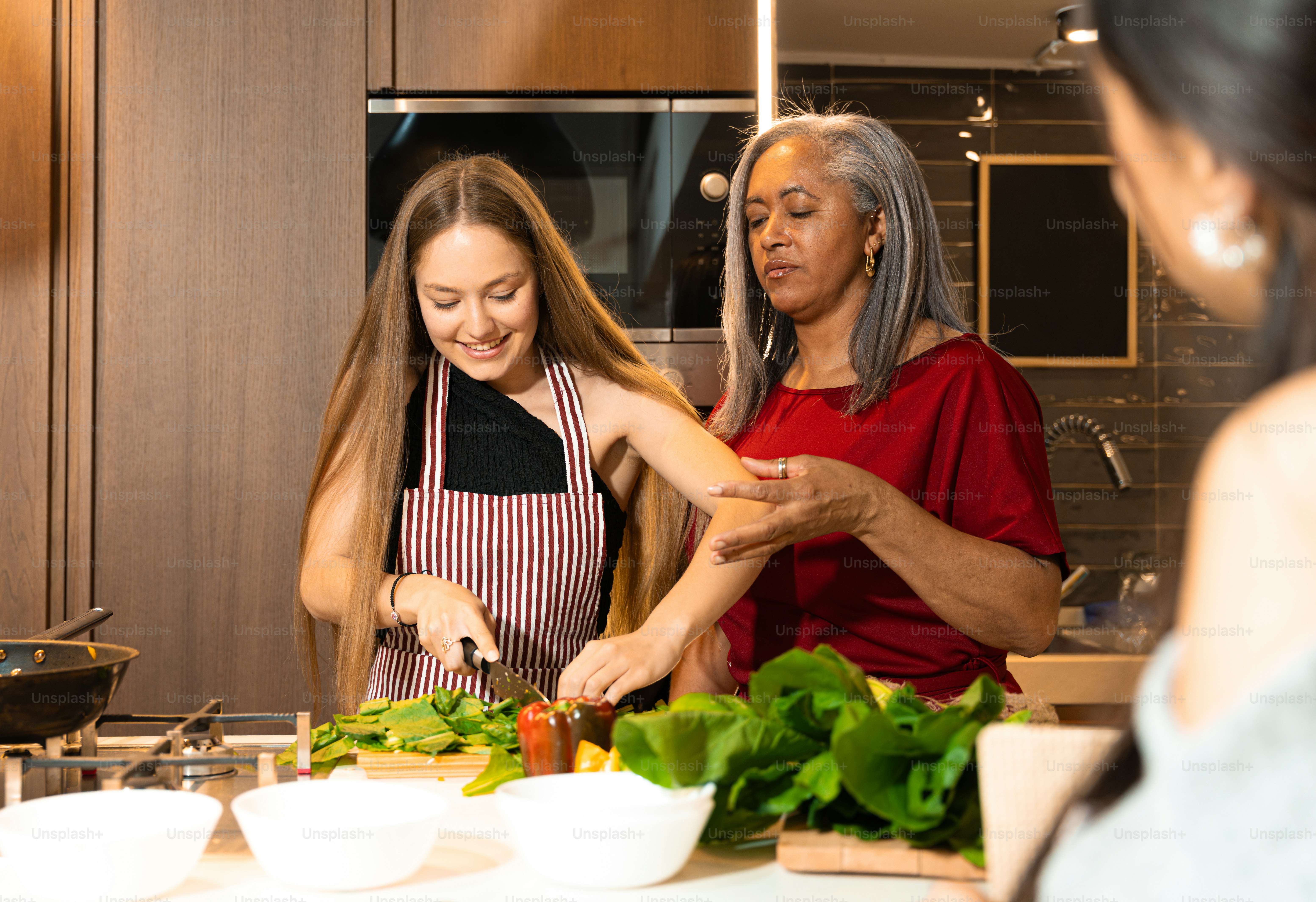 Women cooking together in modern kitchen - Photo on Unsplash+