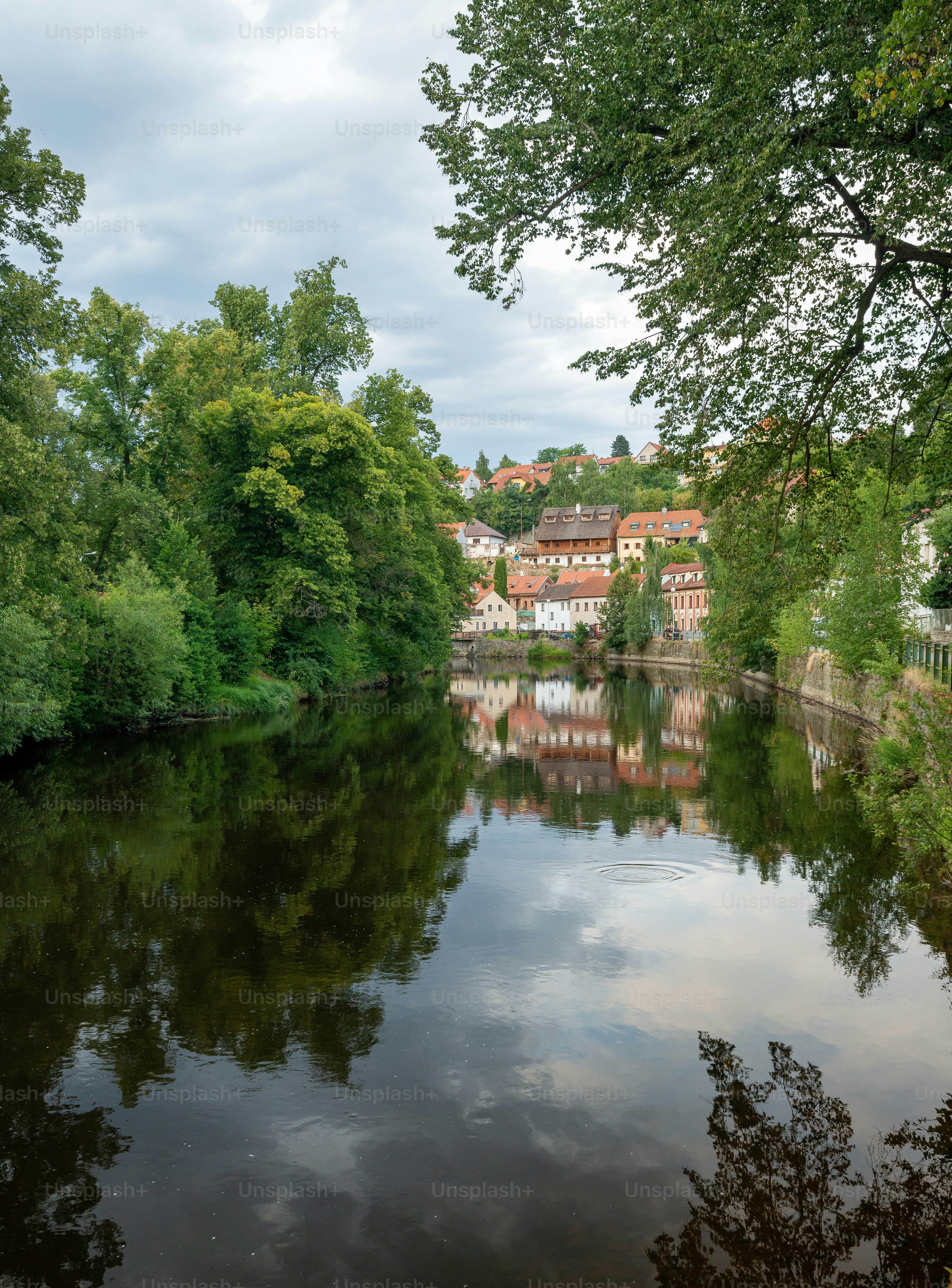 Historic houses along river in Český Krumlov - Photo on Unsplash+