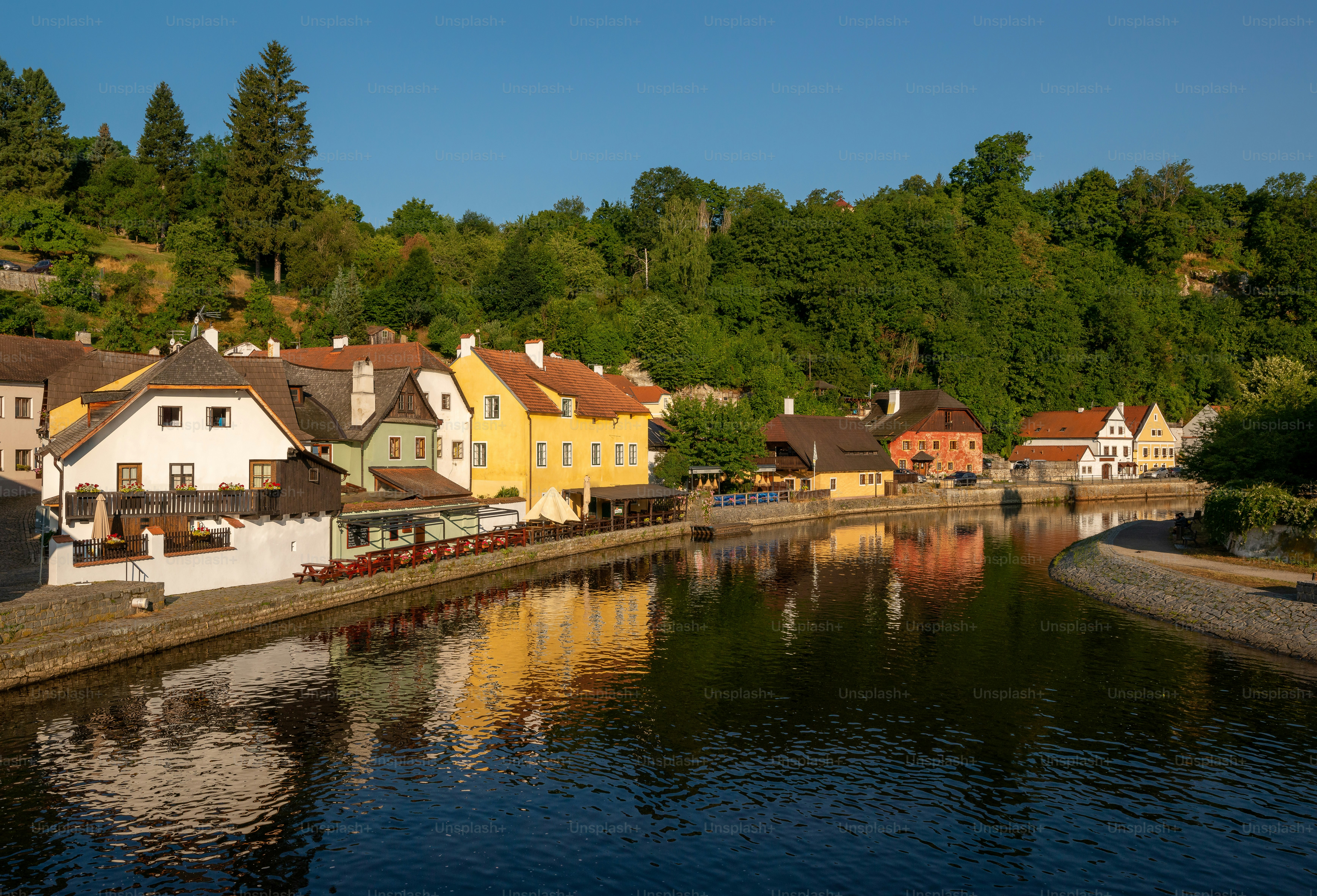 Historic houses along river in Český Krumlov - Photo on Unsplash+