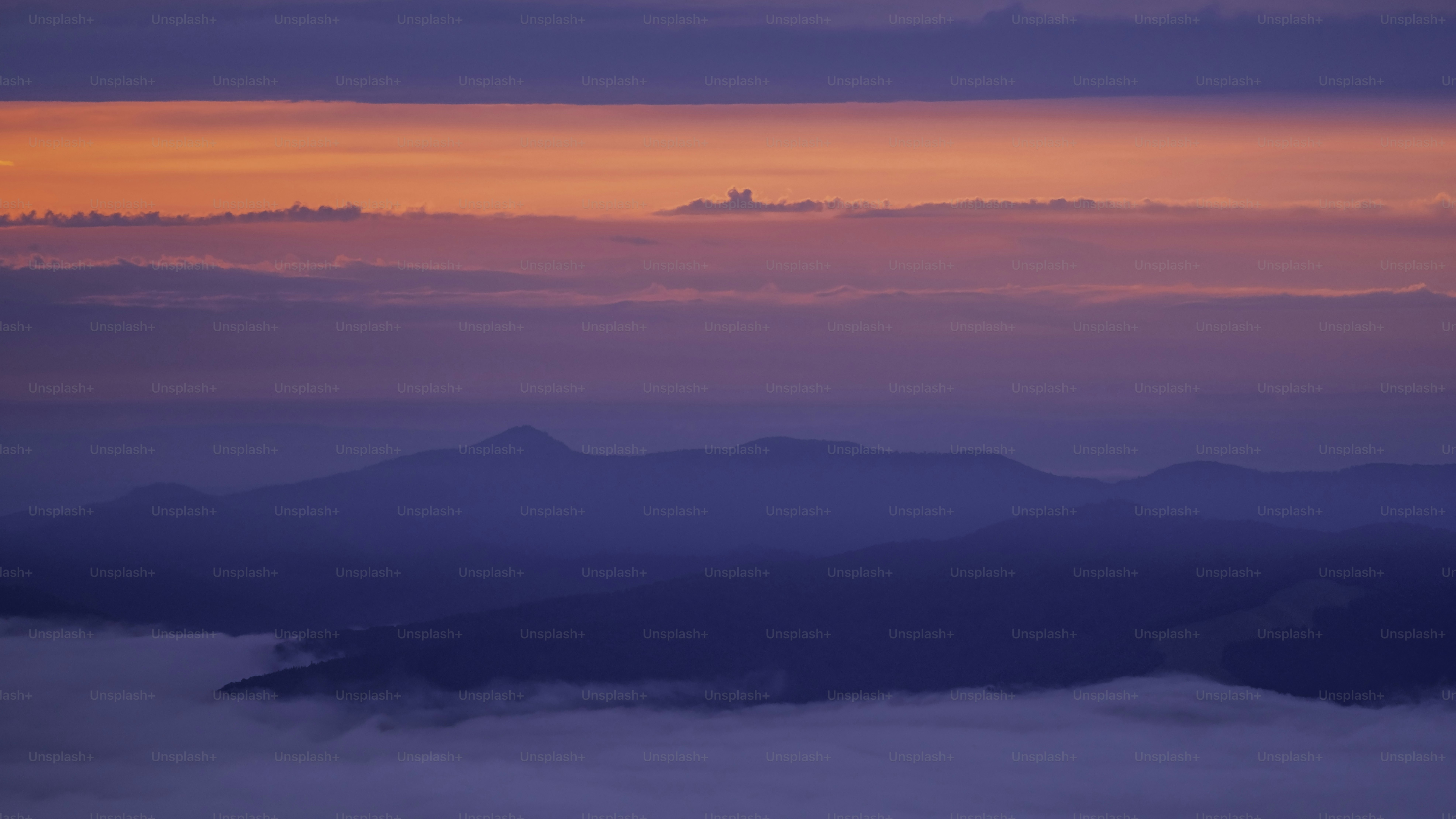 Mountain silhouettes under pink purple sky - Photo on Unsplash+