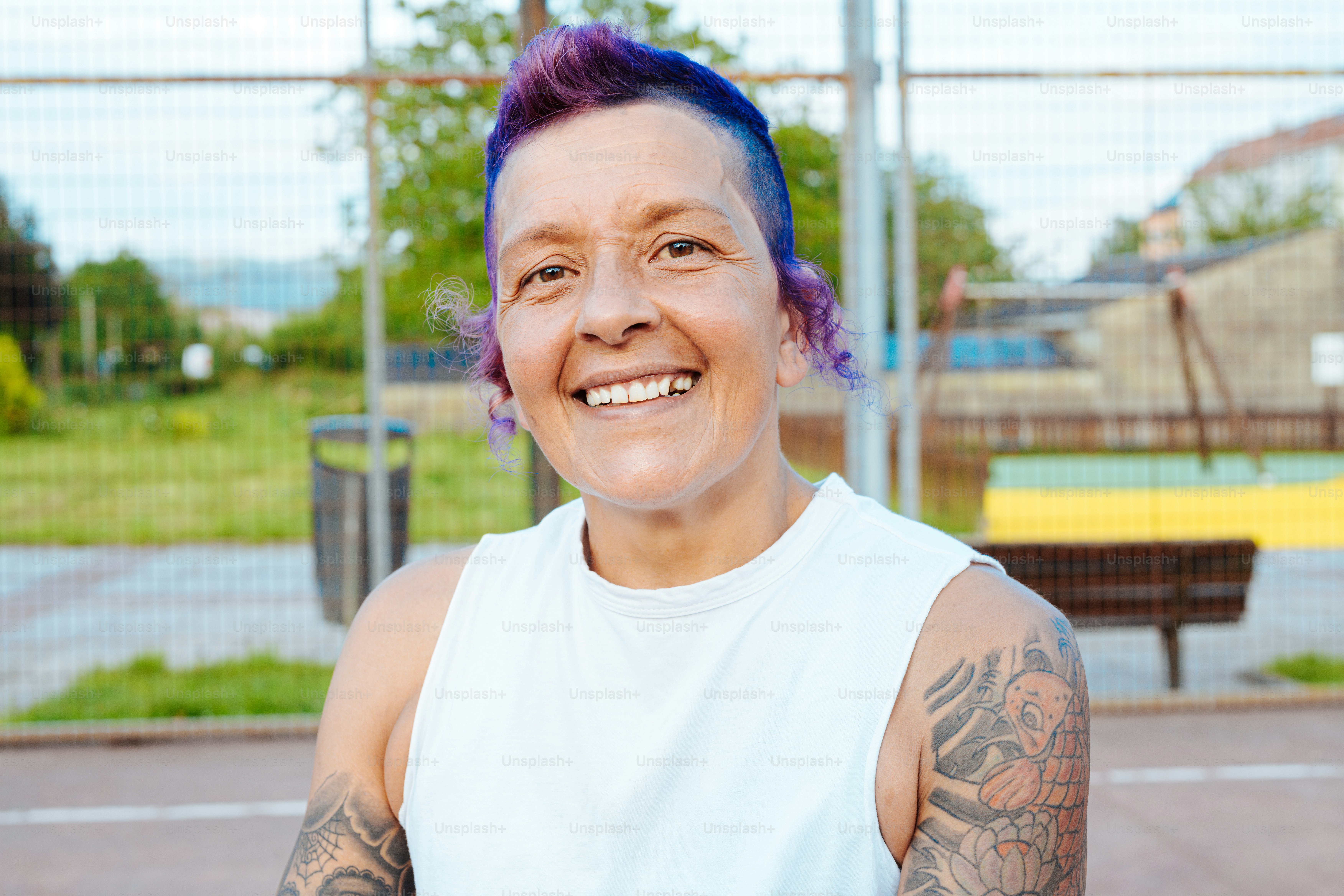 Smiling adult with purple hair - Photo on Unsplash+