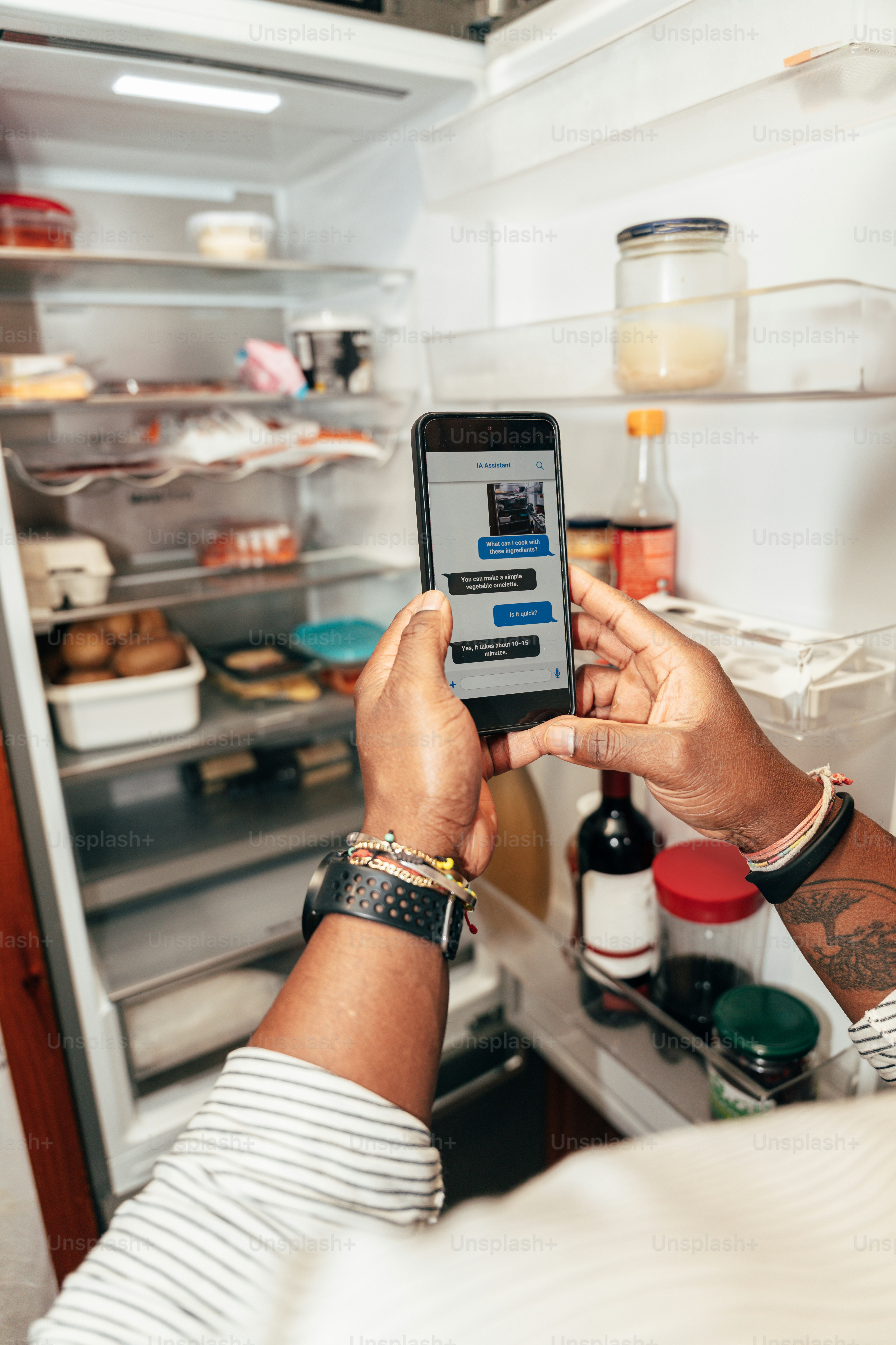 Person holding smartphone over open book - Photo on Unsplash+