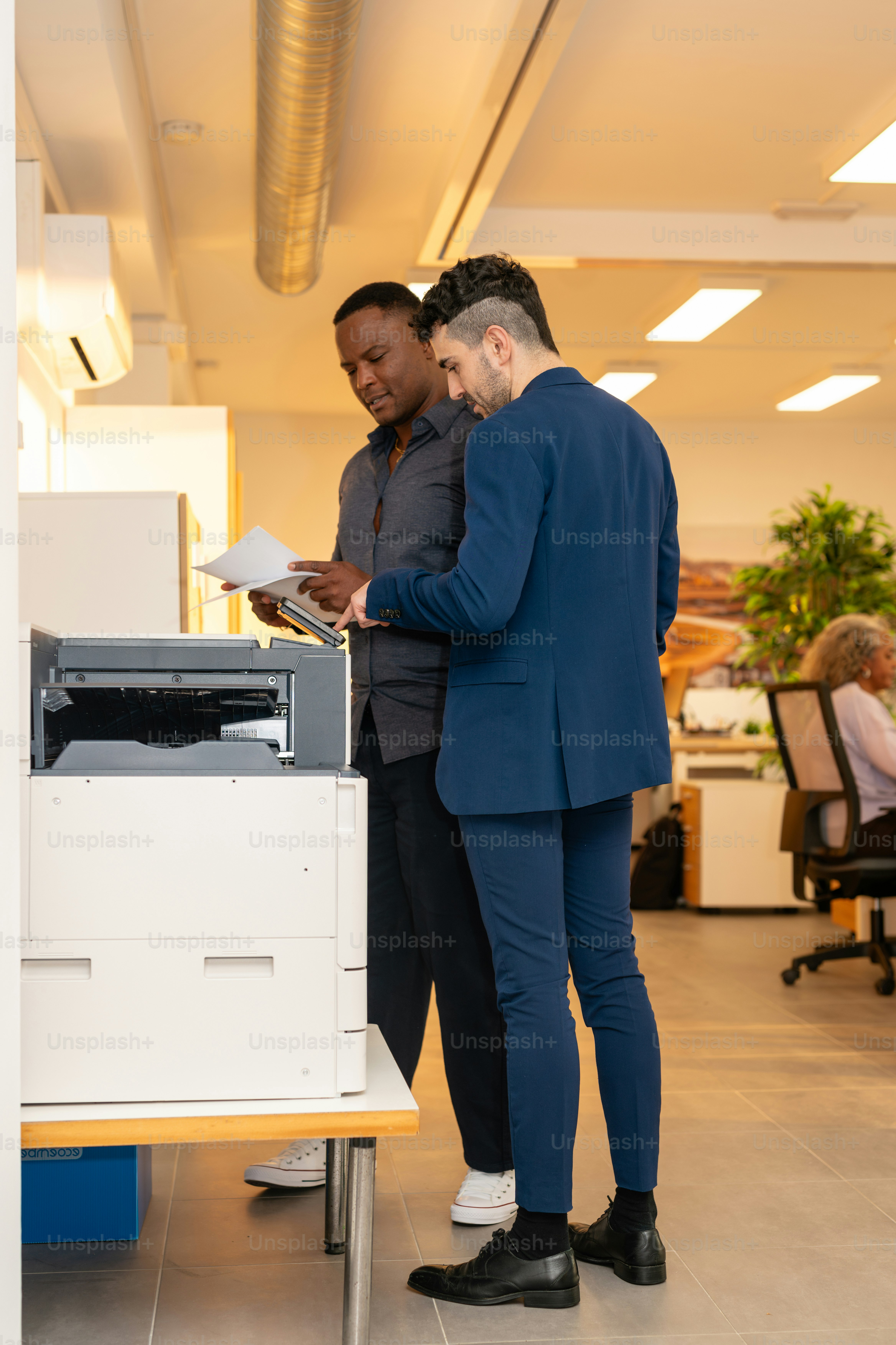 Men using printer in office - Photo on Unsplash+