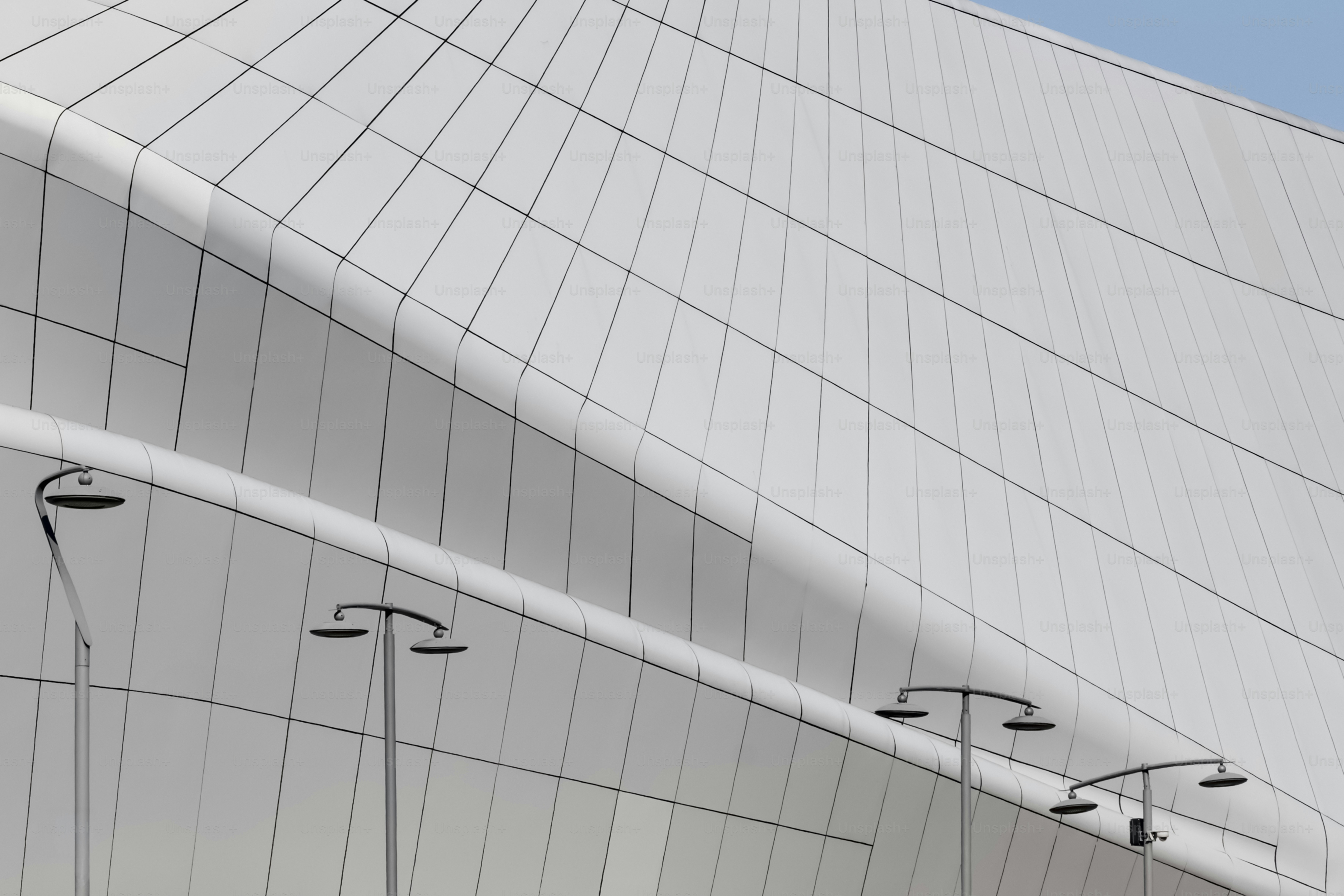 Modern building facade with metal waves - Photo on Unsplash+