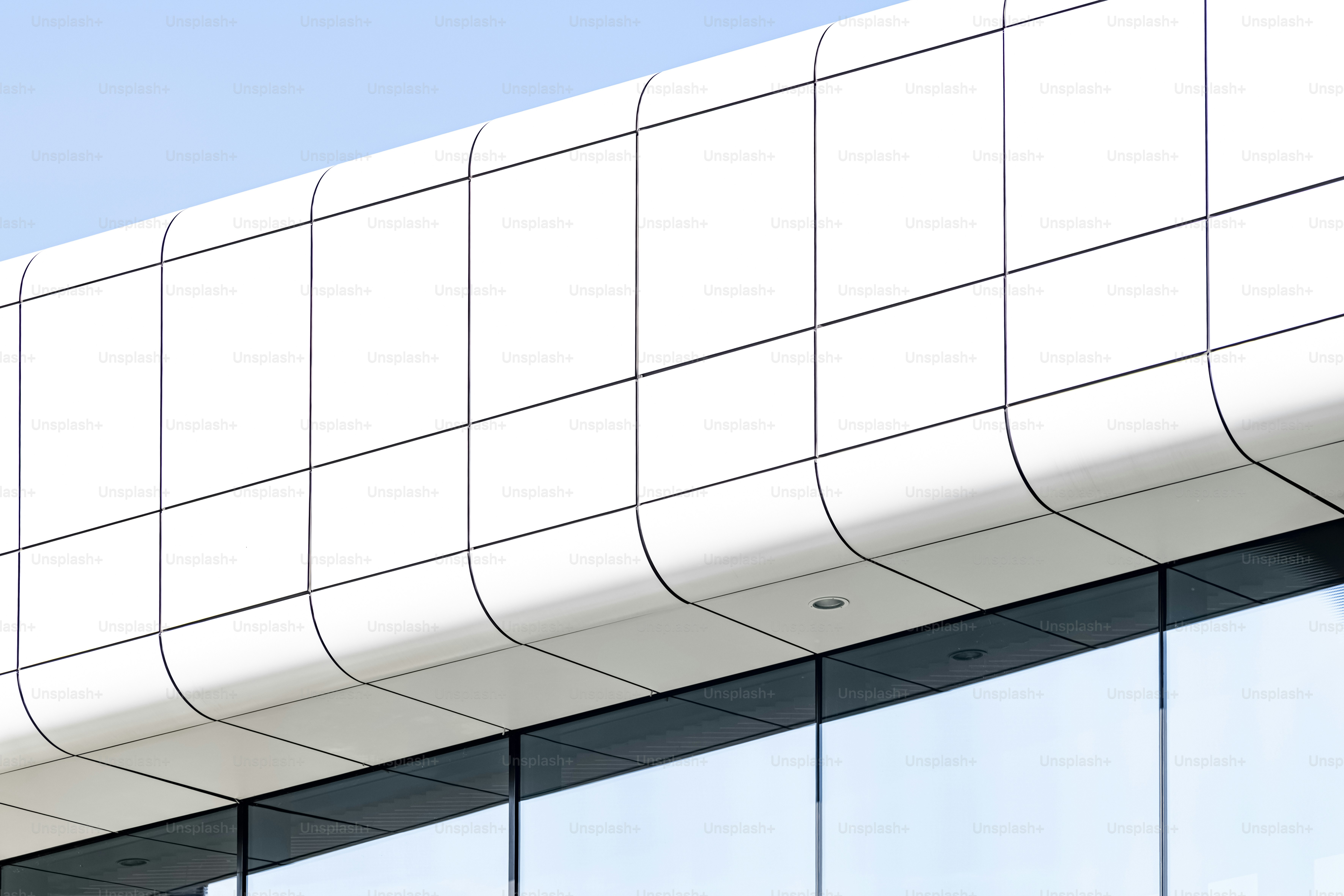Modern white building with curved facade - Photo on Unsplash+