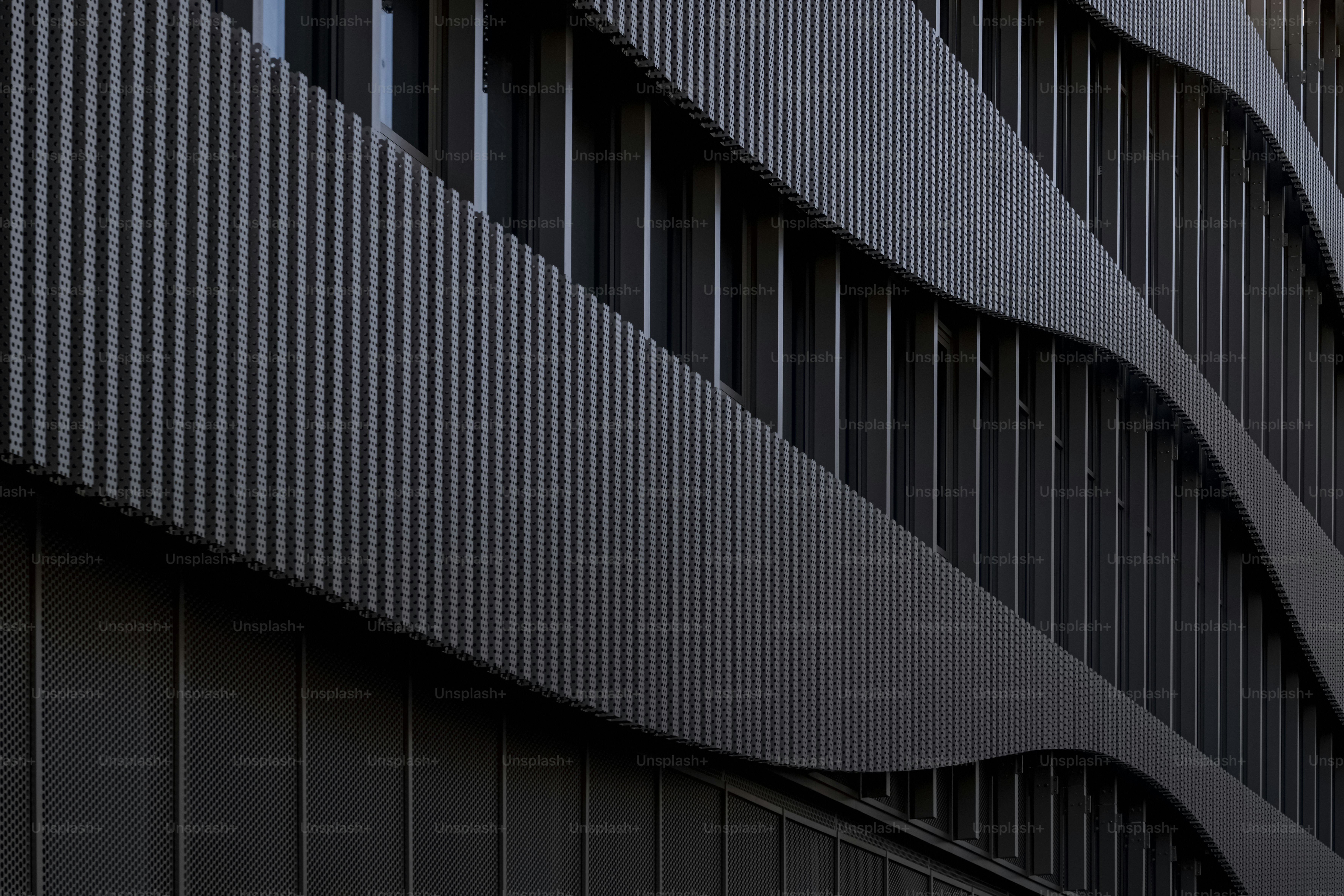 Modern building facade with metal waves - Photo on Unsplash+