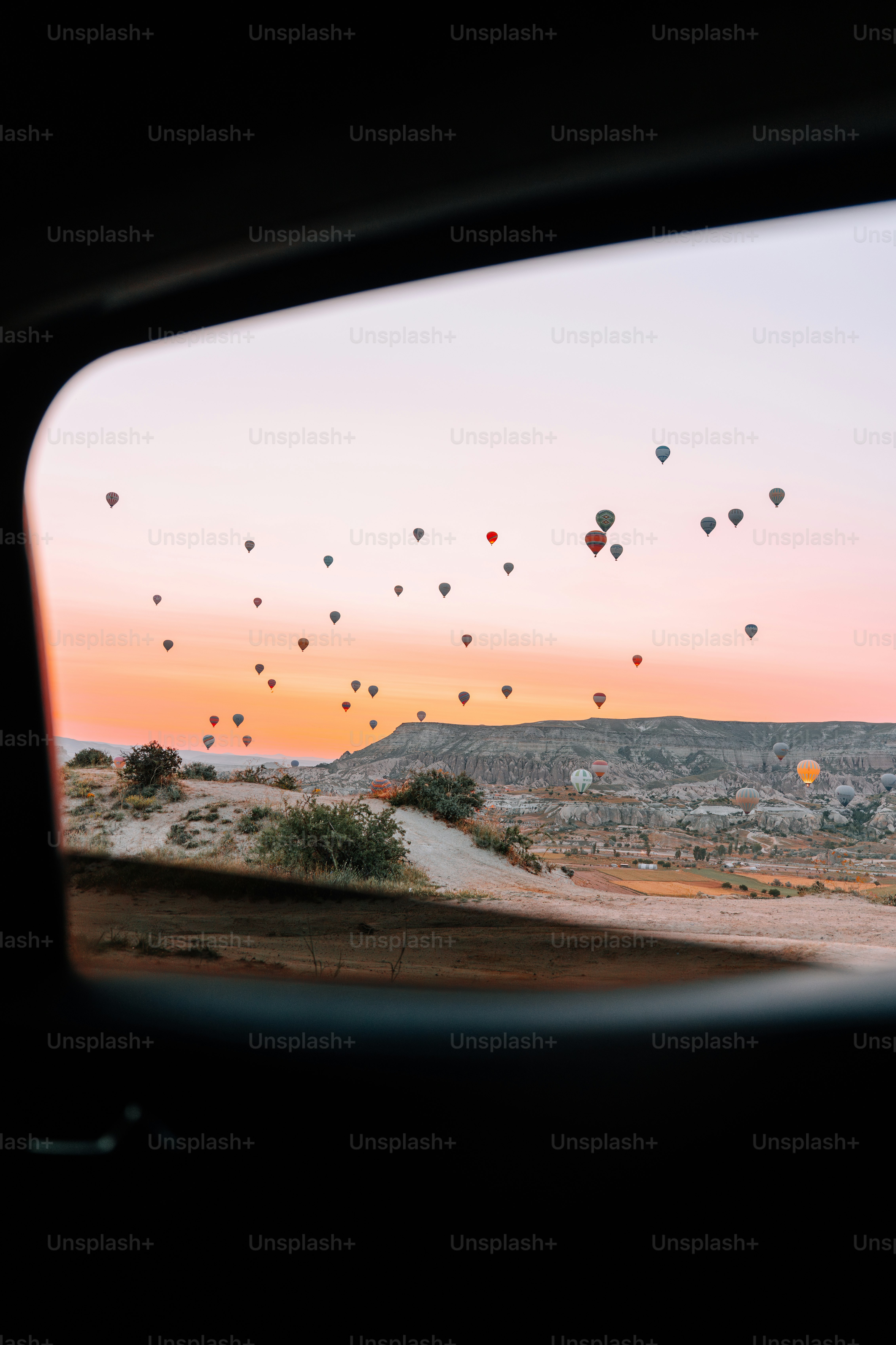 Hot air balloons over rocky landscape - Photo on Unsplash+