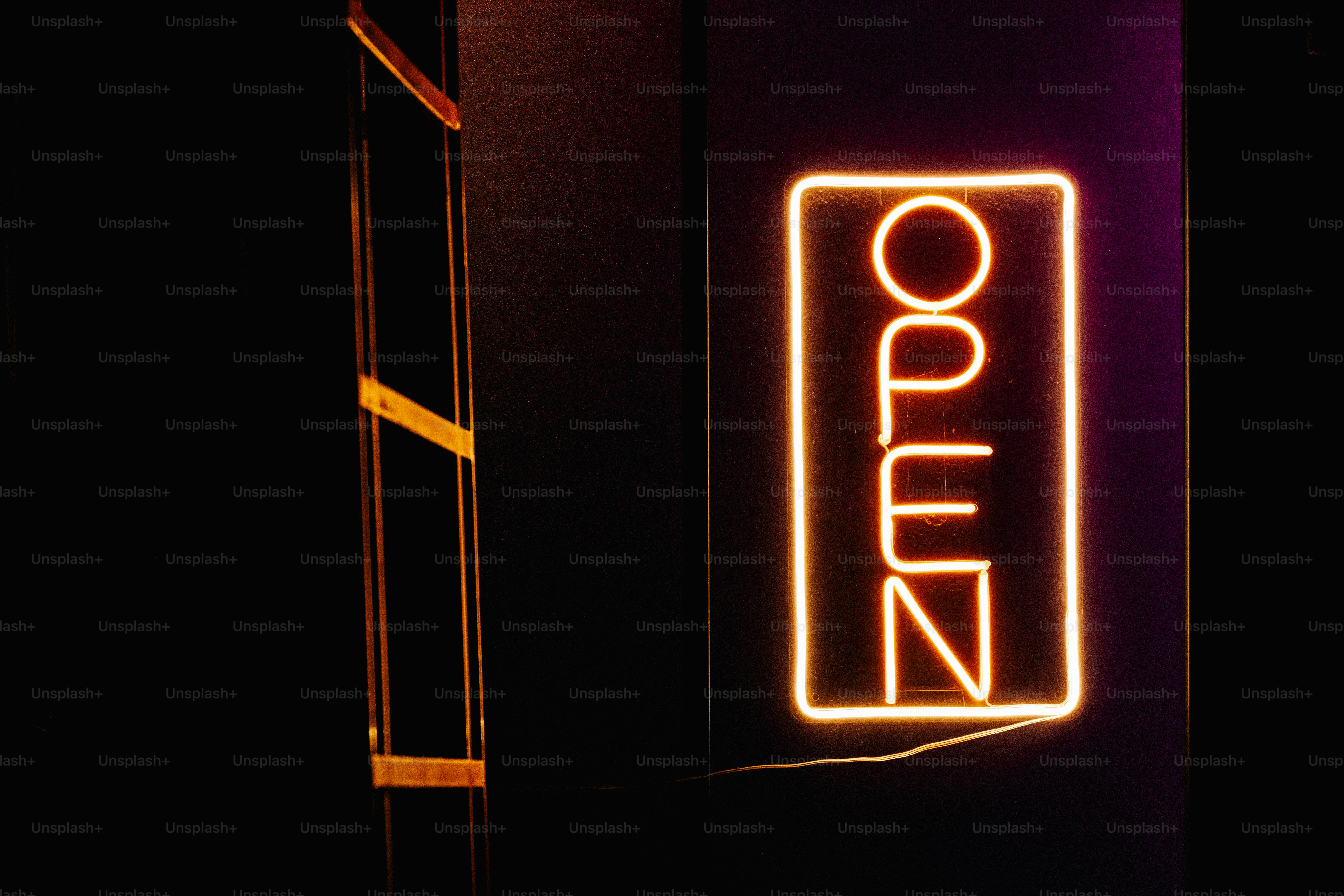Neon open sign on dark wall - Photo on Unsplash+