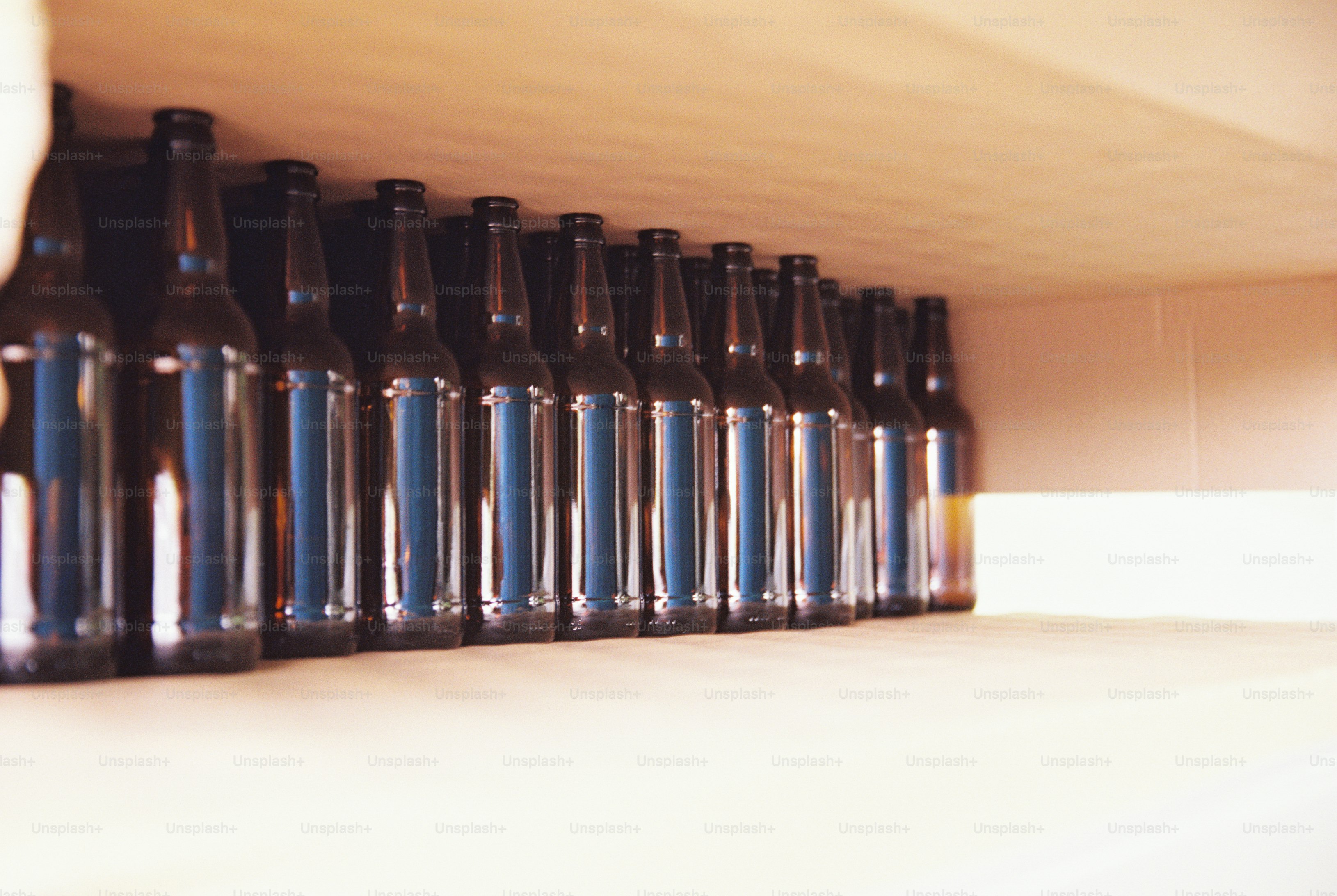 Empty brown bottles in cardboard box - Photo on Unsplash+