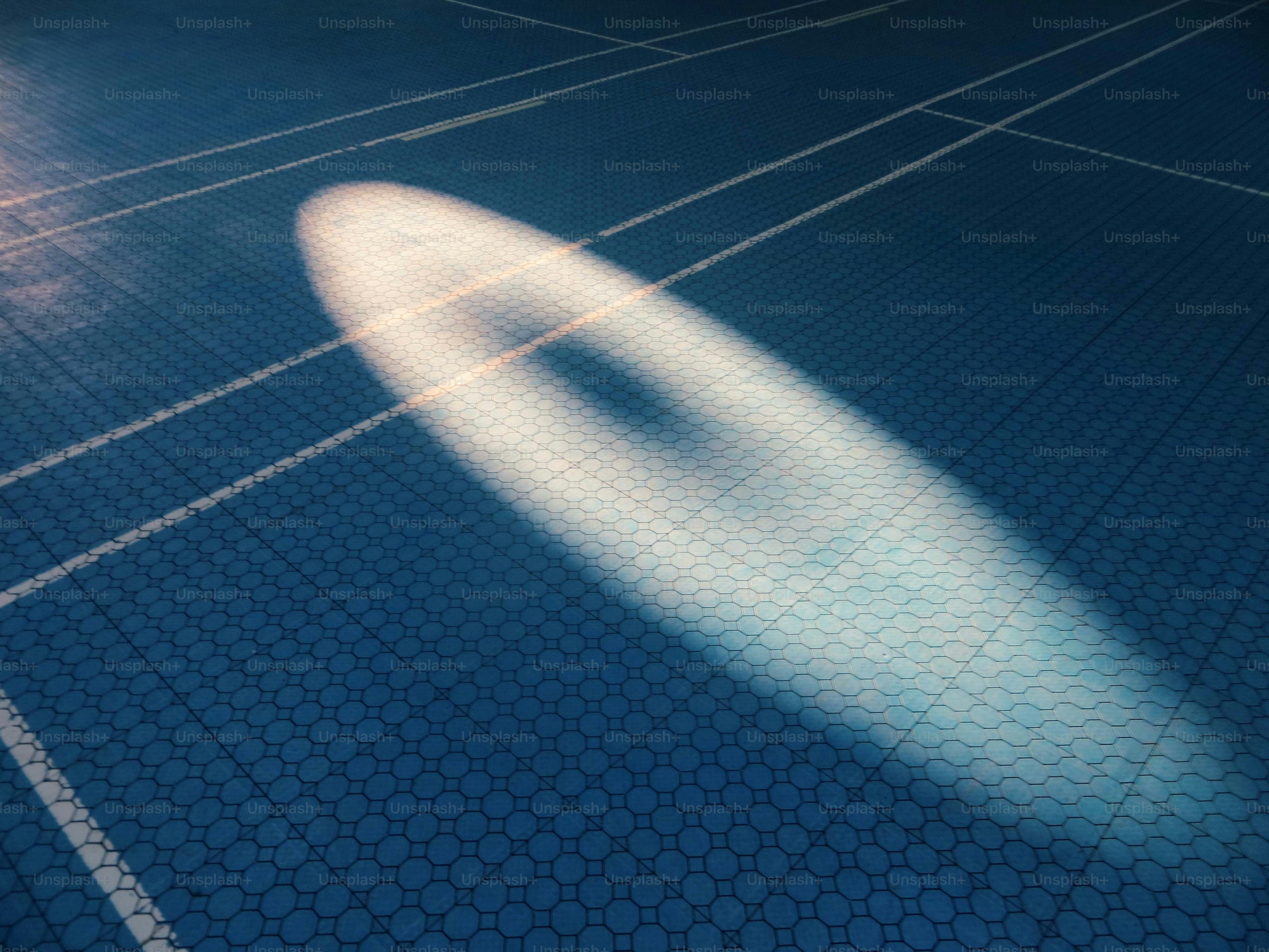 Oval light on blue tiled floor - Photo on Unsplash+