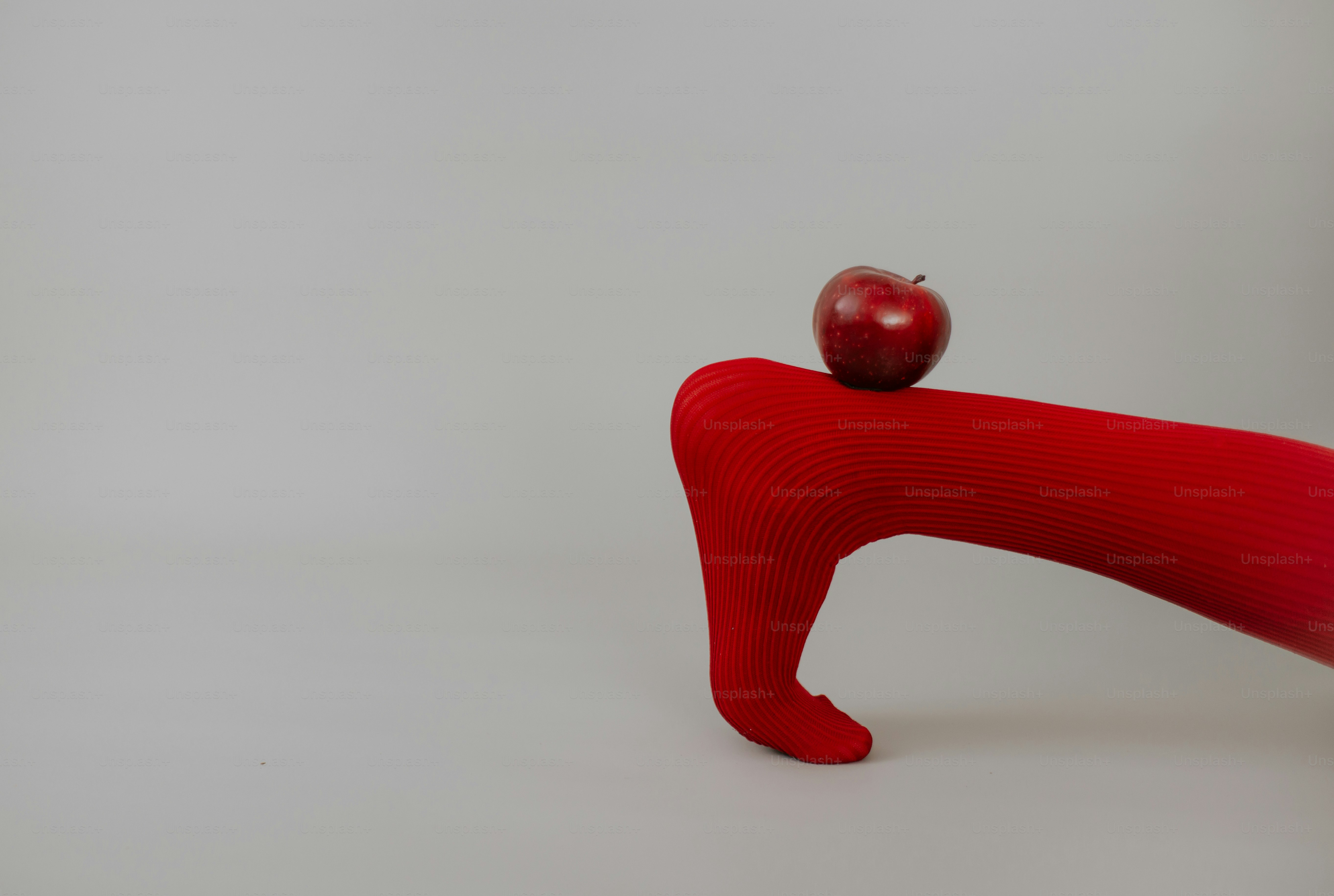 Red apple on red sock - Photo on Unsplash+