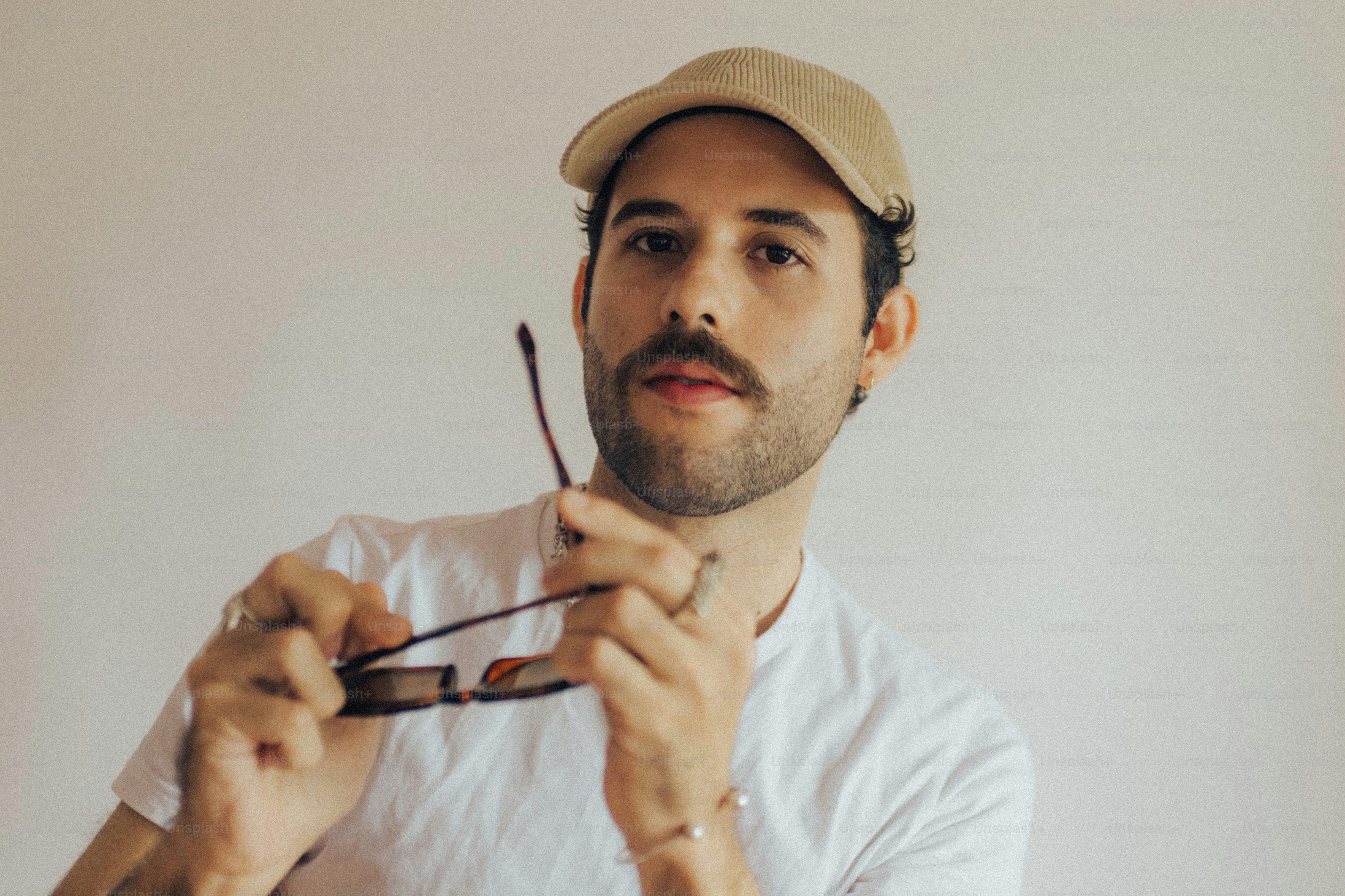 Man with mustache wearing beige cap - Photo on Unsplash+