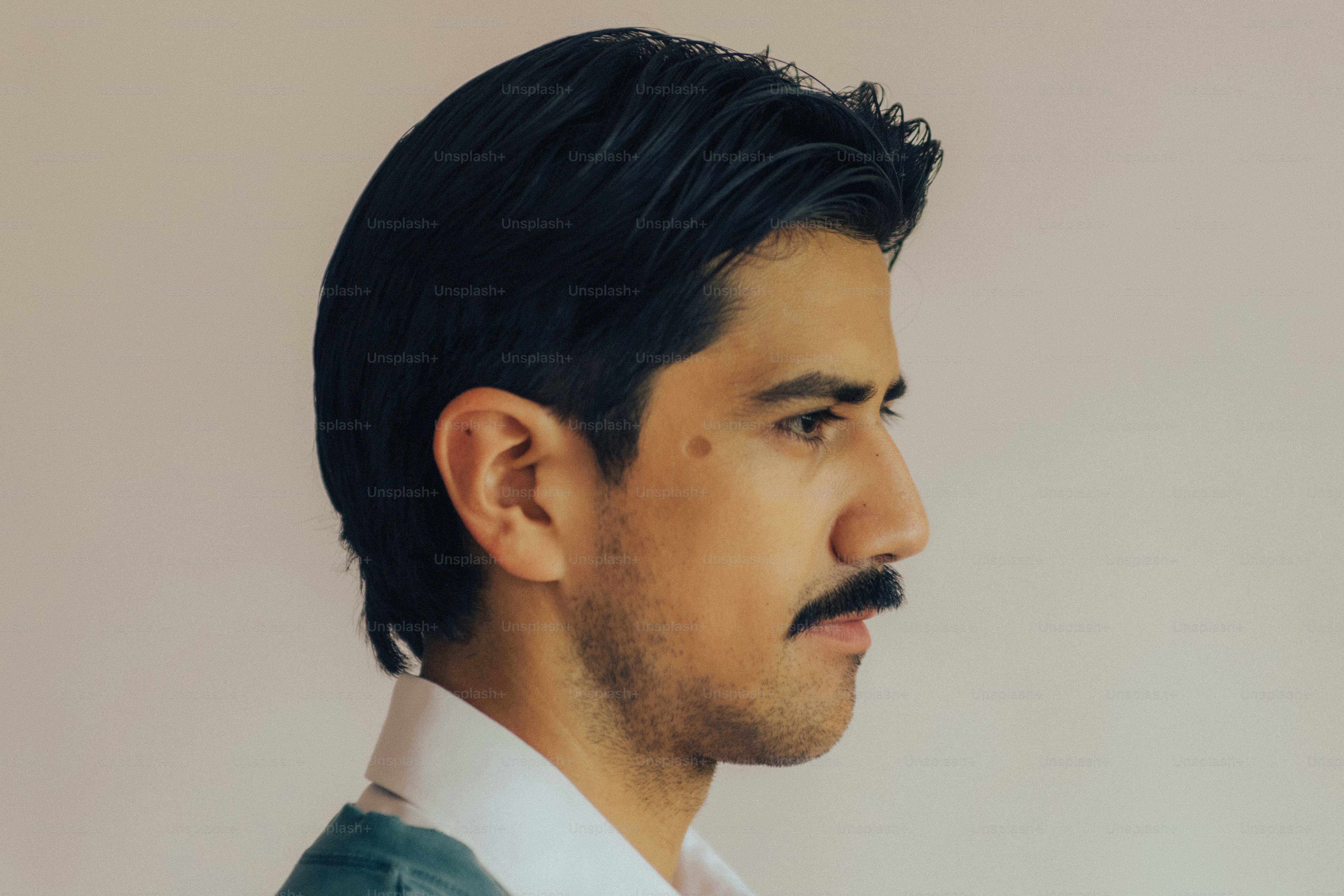 Man with mustache in striped shirt - Photo on Unsplash+