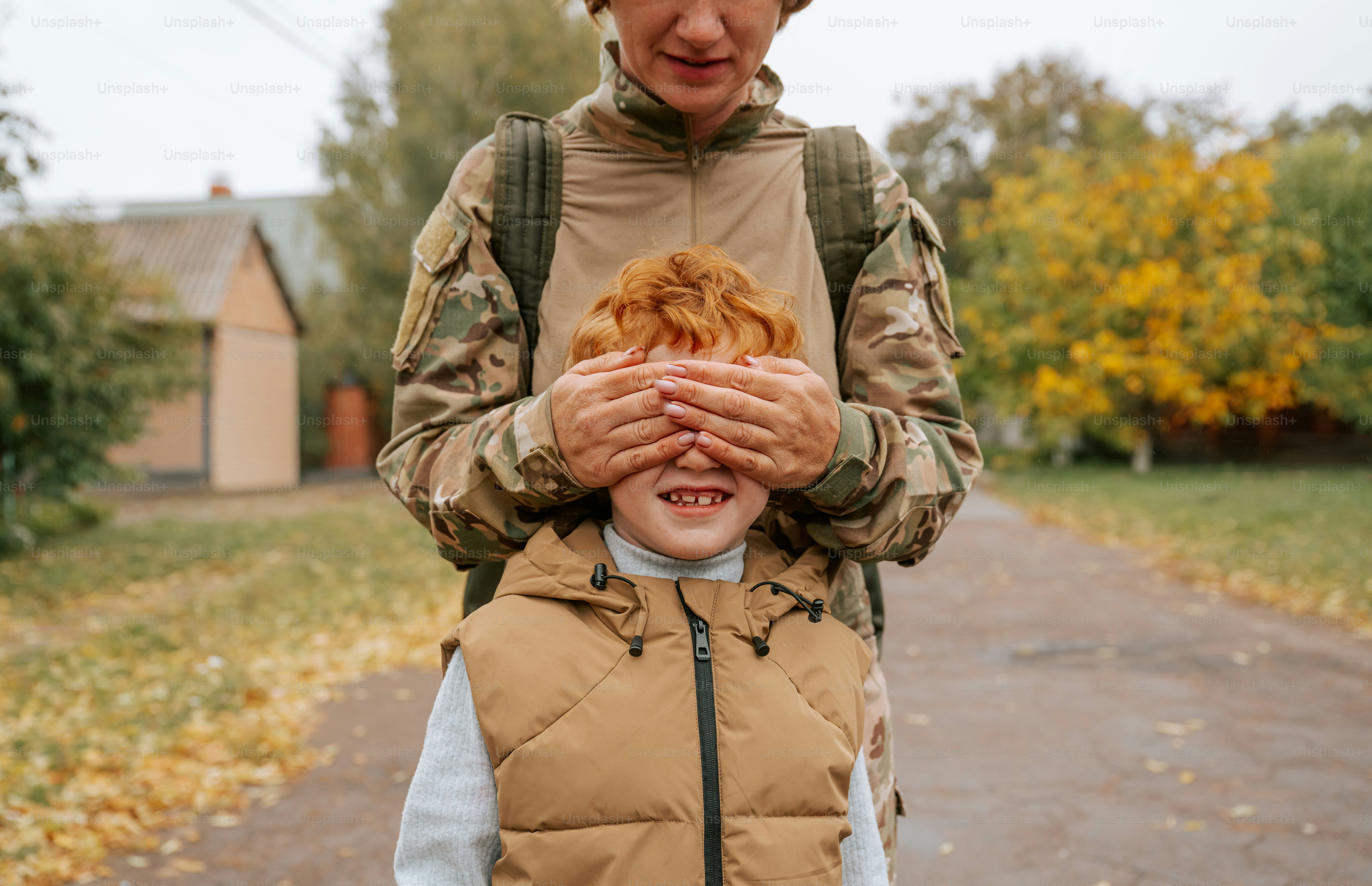 Adult covering eyes of child - Photo on Unsplash+