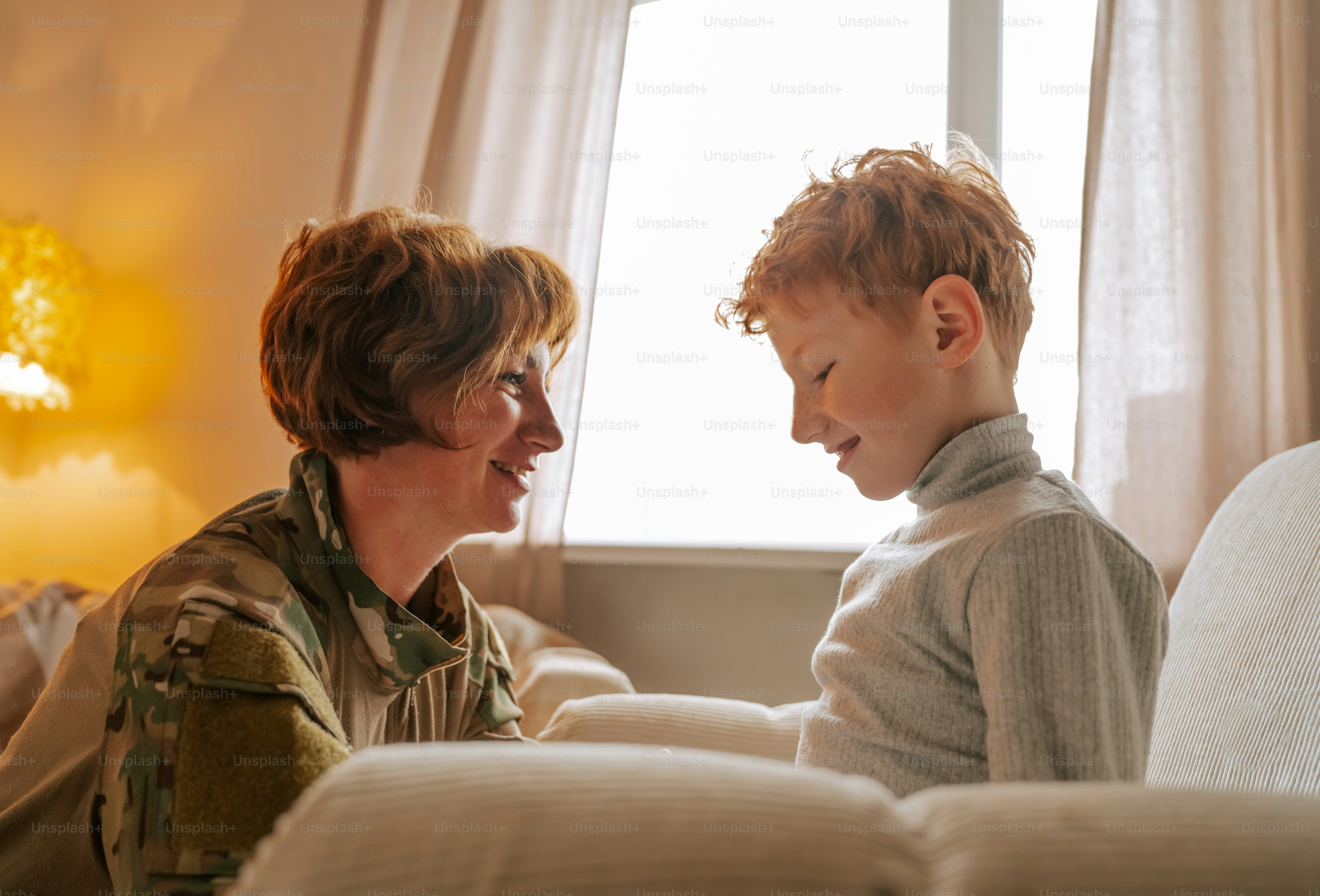 Woman in uniform smiling at child - Photo on Unsplash+