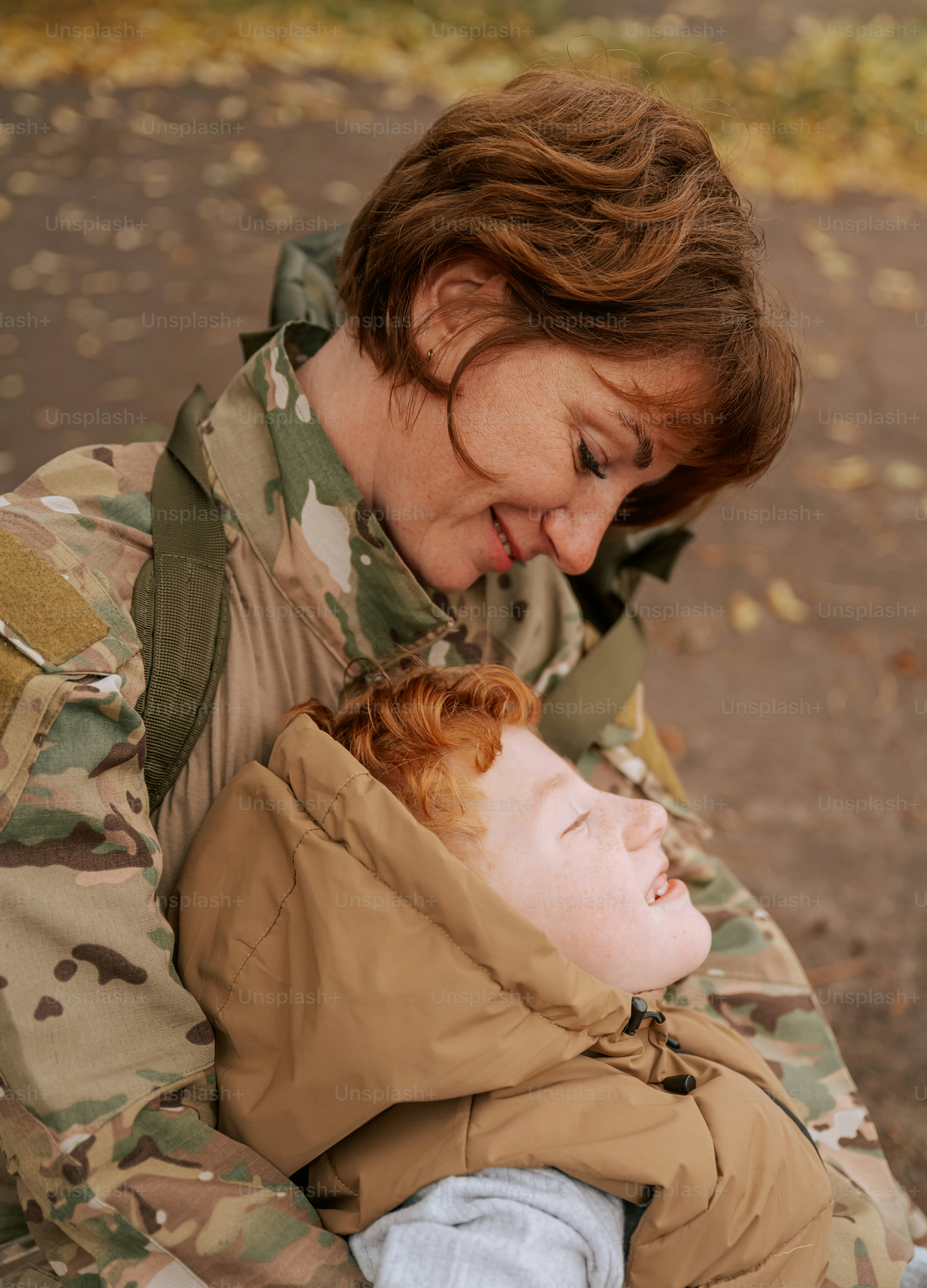 Person in camouflage holding child hand - Photo on Unsplash+