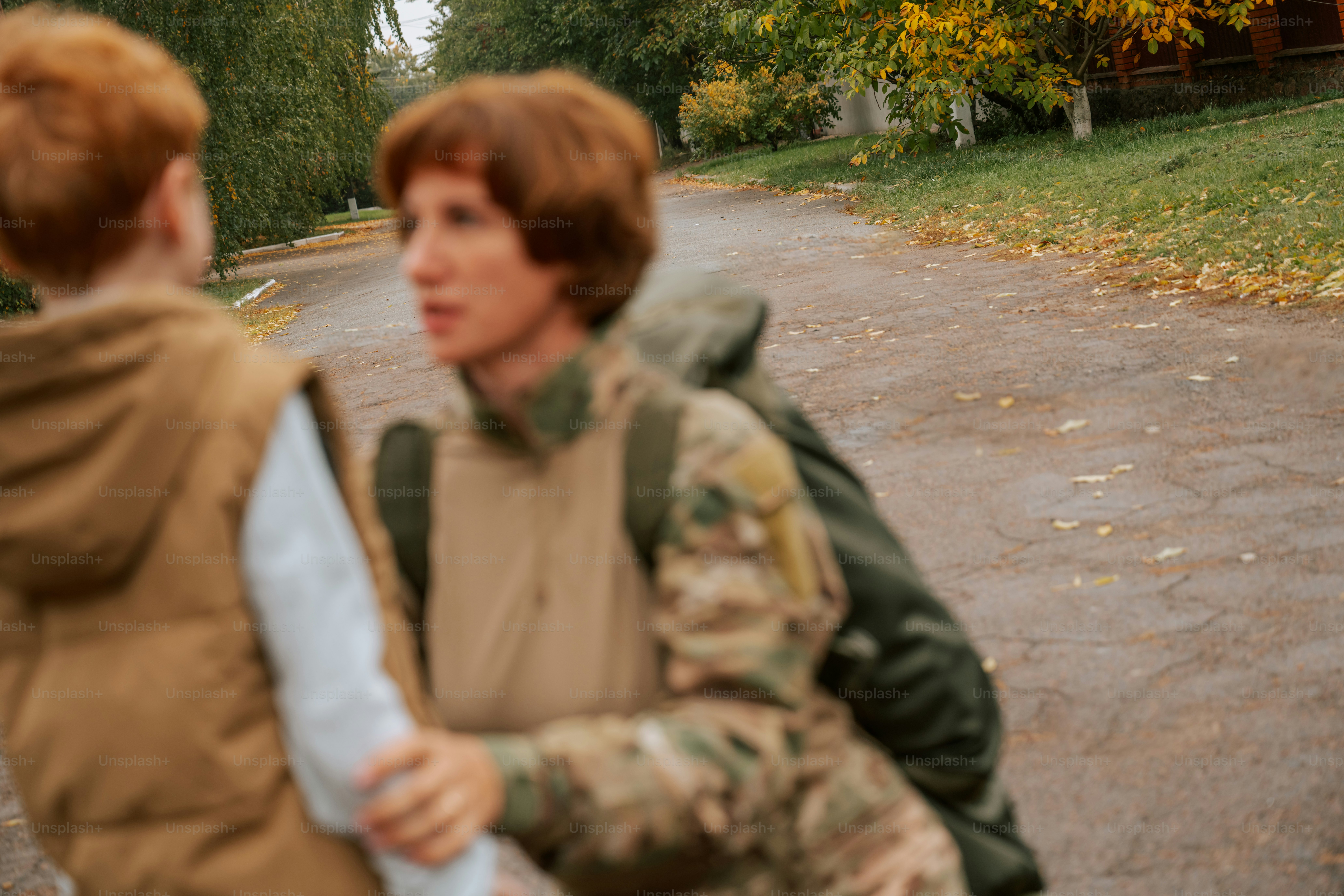 Person in camouflage holding child hand - Photo on Unsplash+
