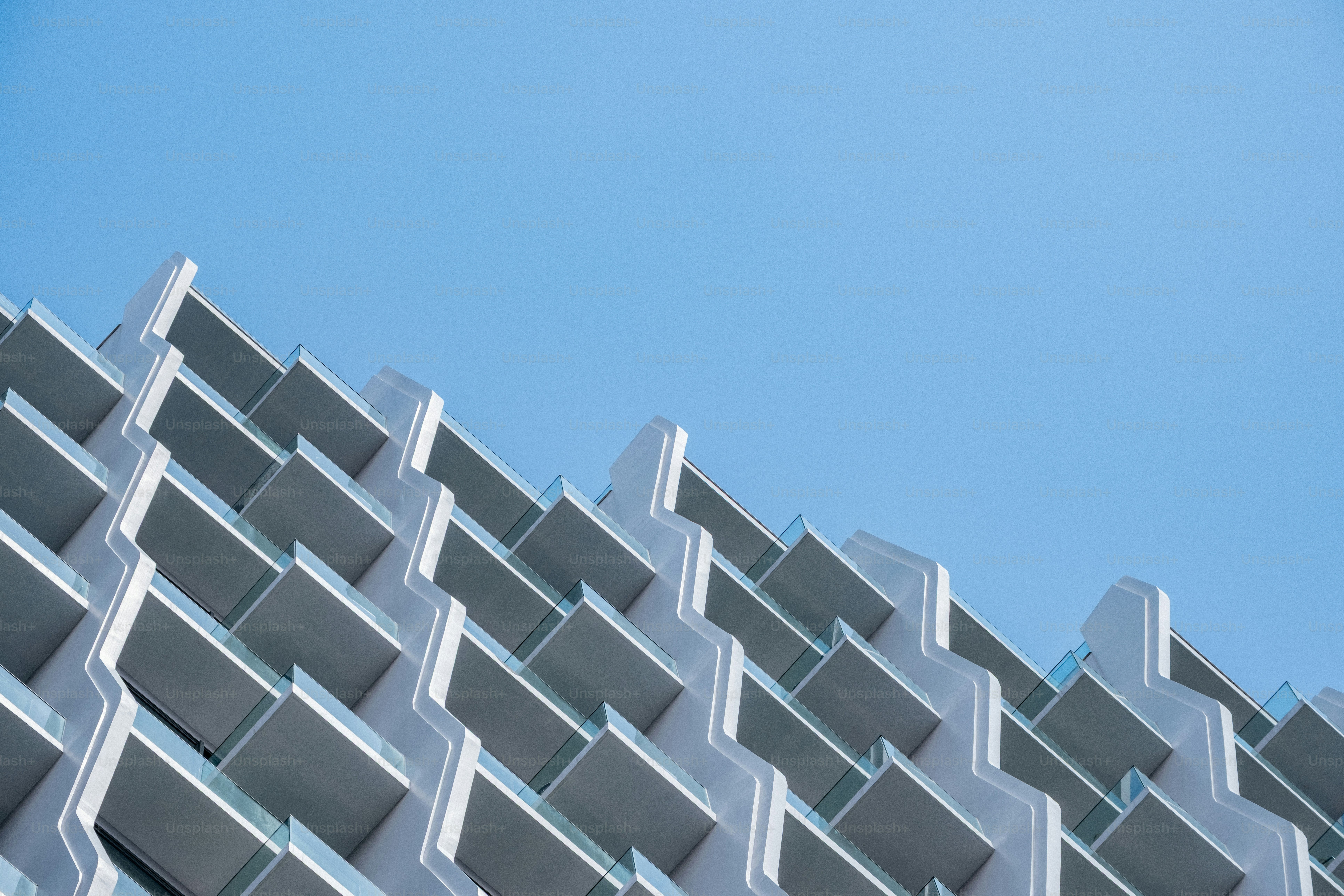 Modern apartment building with stacked balconies - Photo on Unsplash+