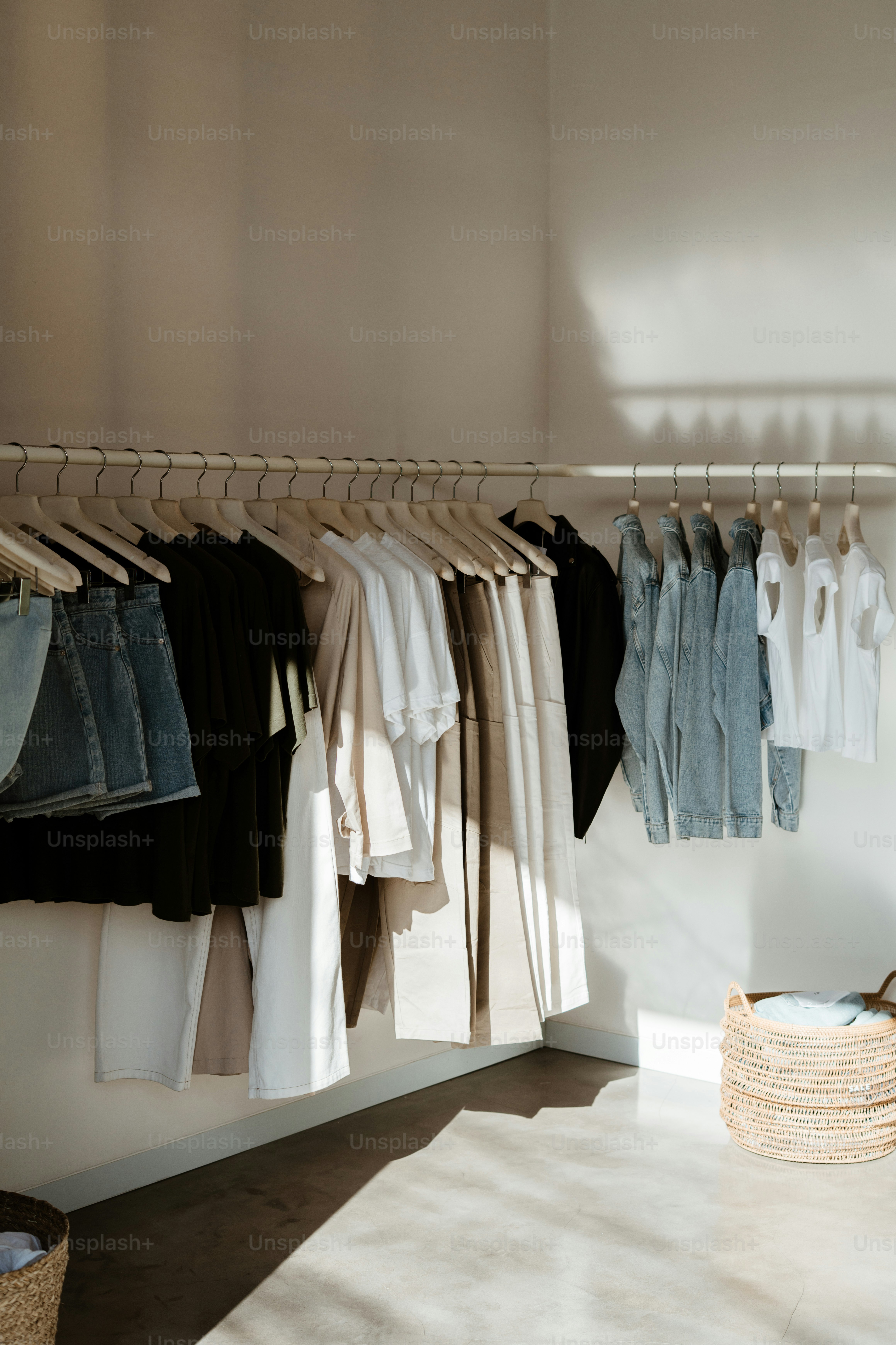Clothes hanging on rack in sunlight - Photo on Unsplash+