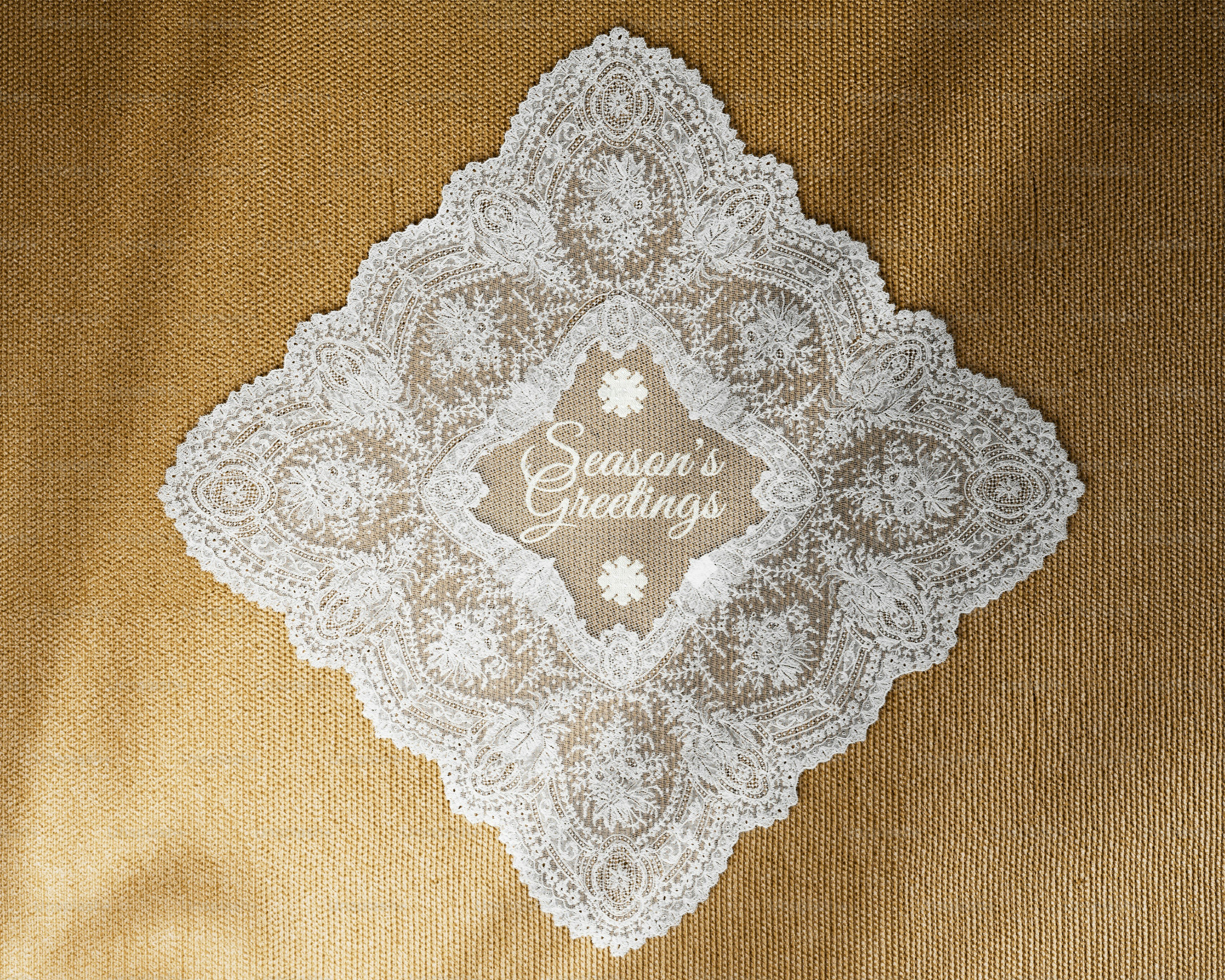 White lace doily on red background - Photo on Unsplash+