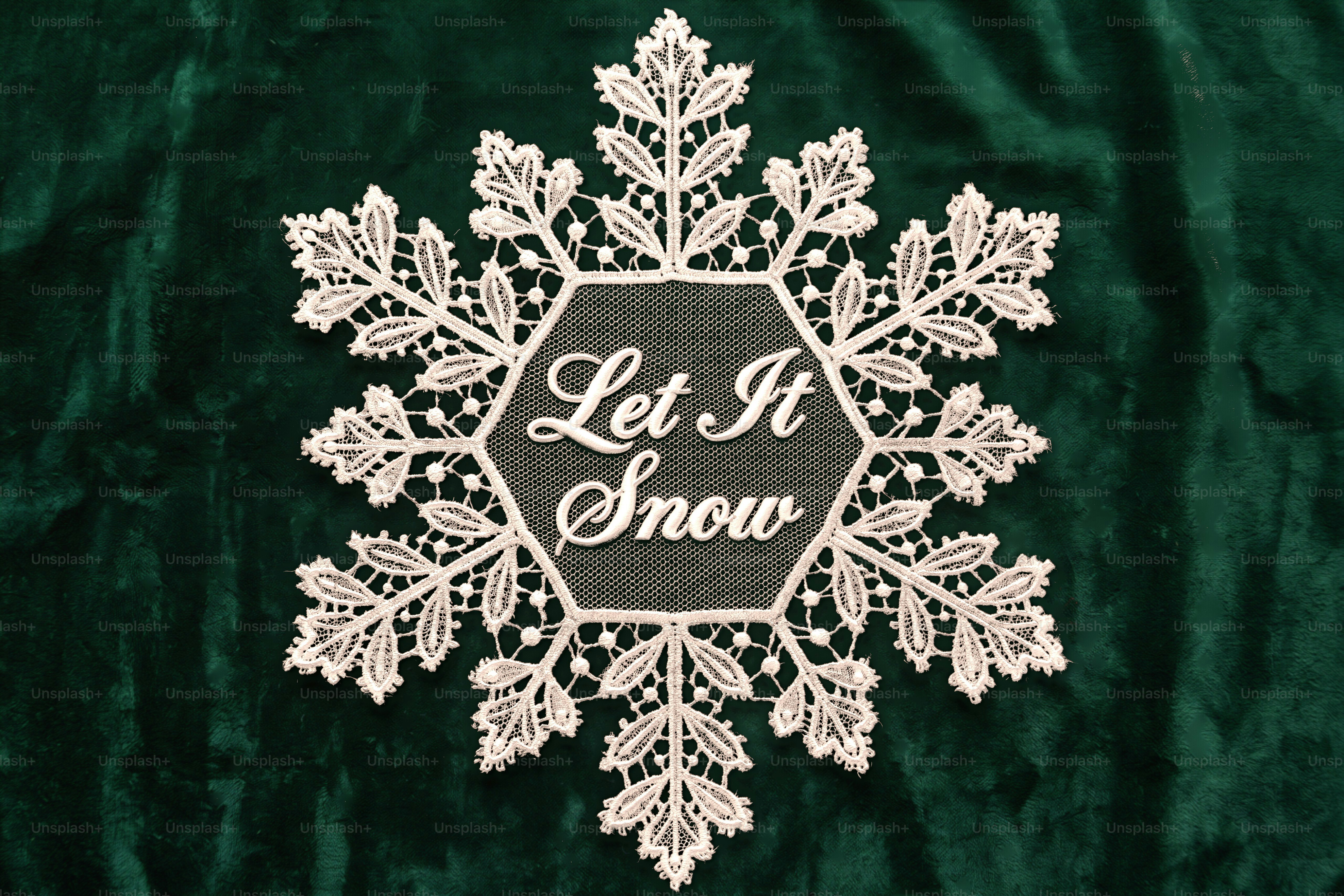 Heart-shaped lace doily with holiday text - Photo on Unsplash+