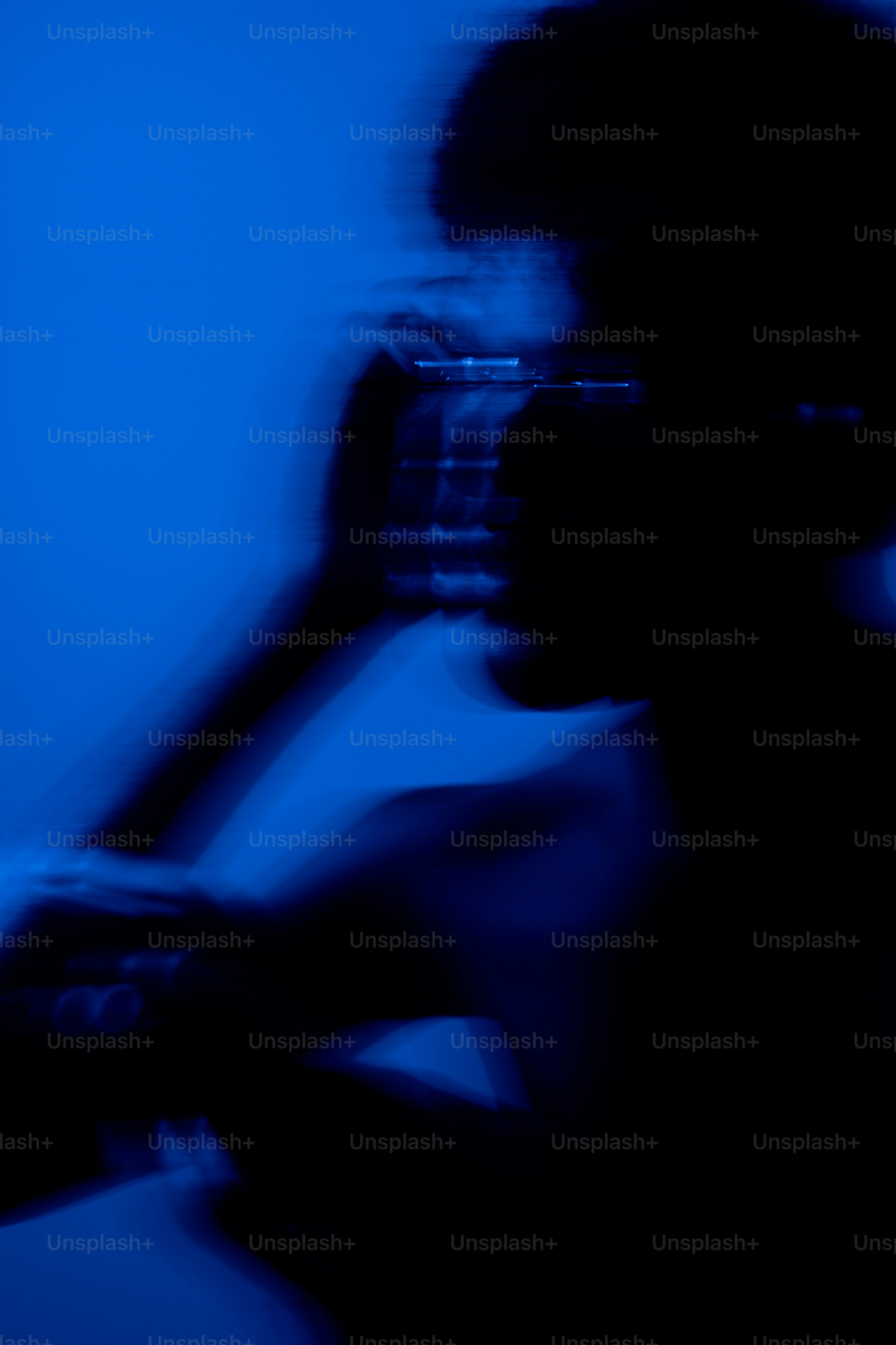 Blurry silhouette of person in blue light - Photo on Unsplash+