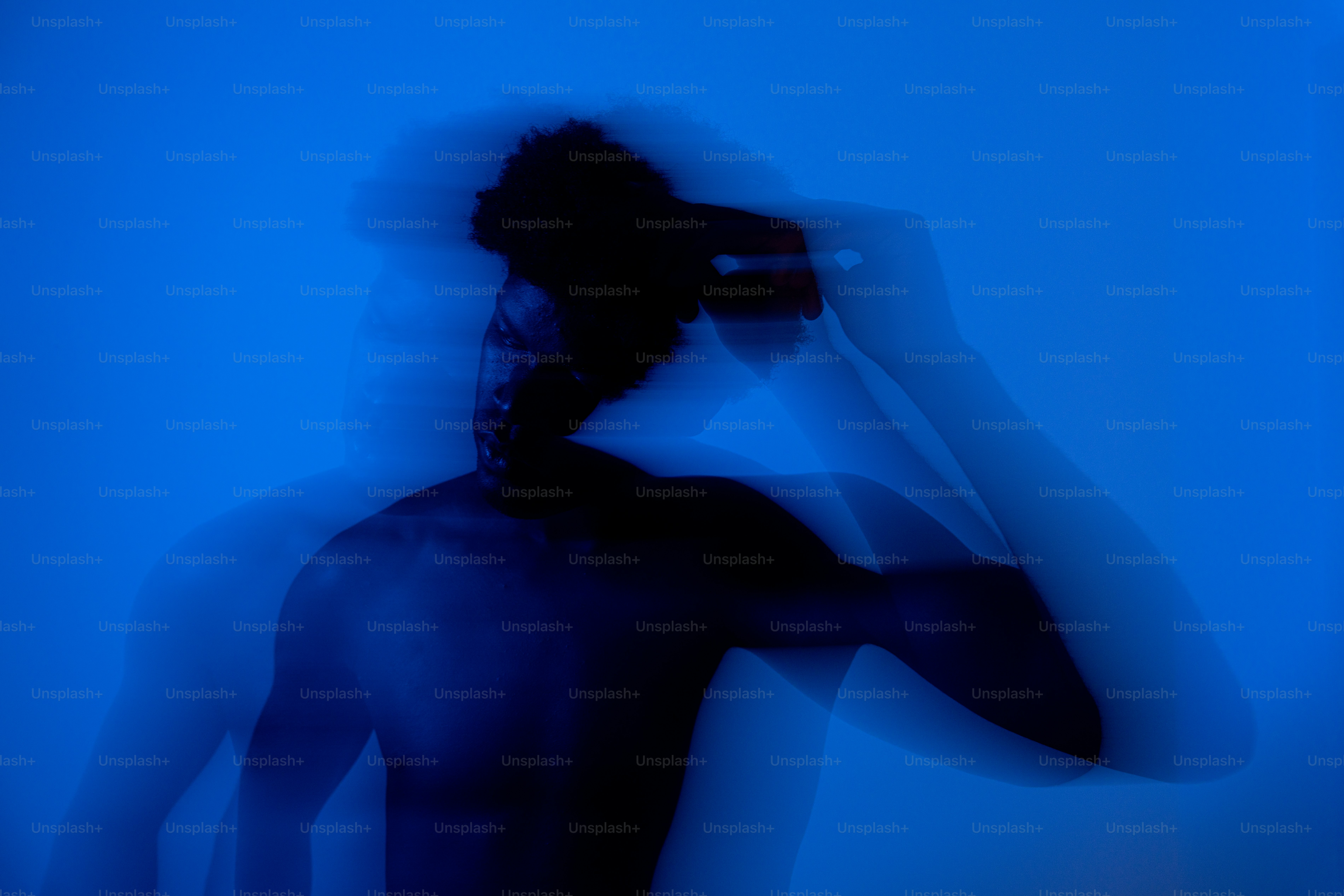 Blurry silhouette of person in blue light - Photo on Unsplash+