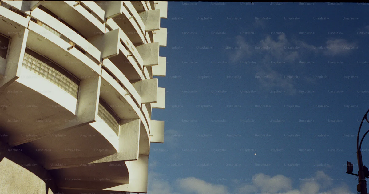 Normal Calendar Design Curved white building with balconies - Photo on Unsplash+