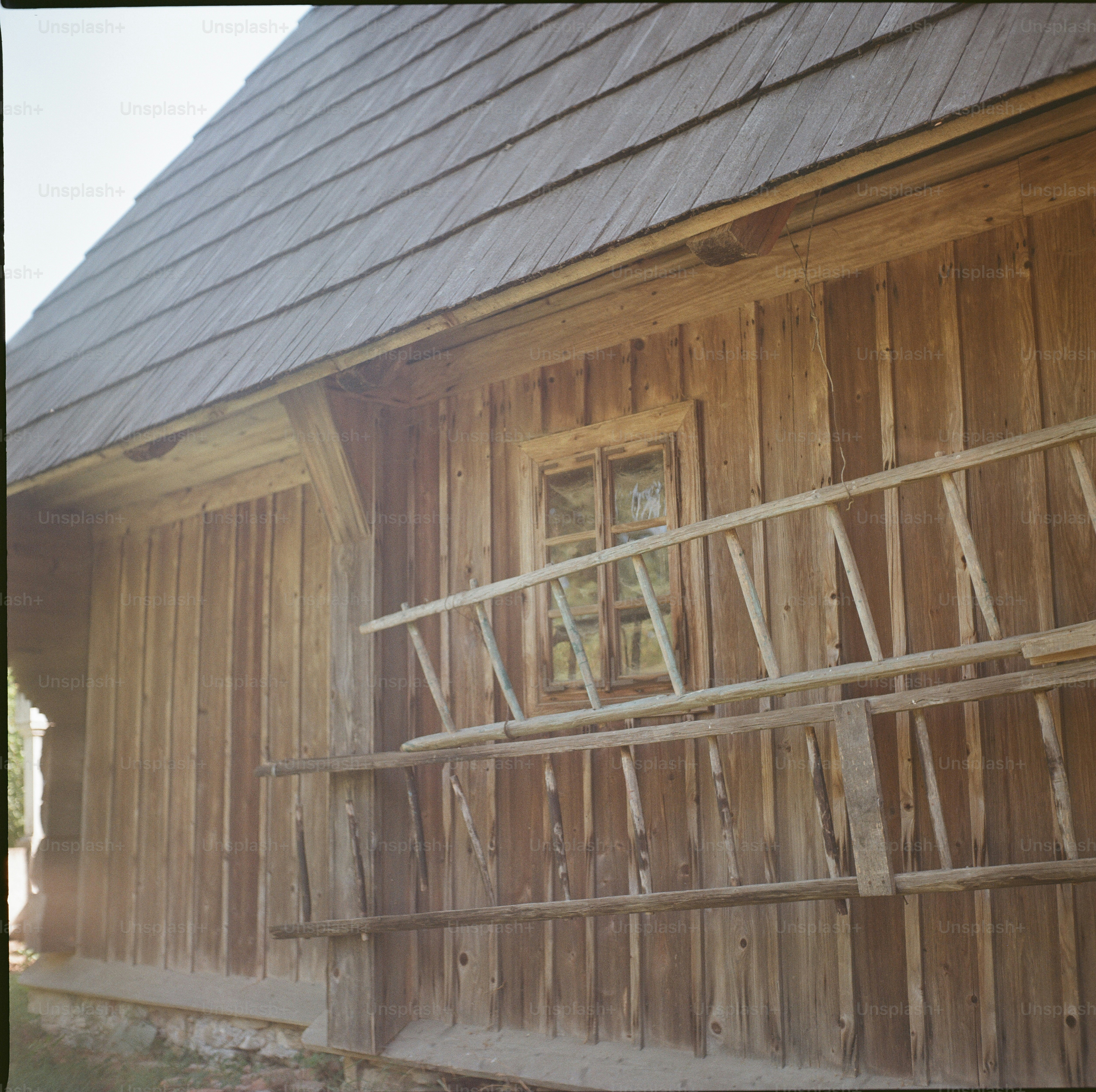 Rustic wooden cabin with ladder - Photo on Unsplash+