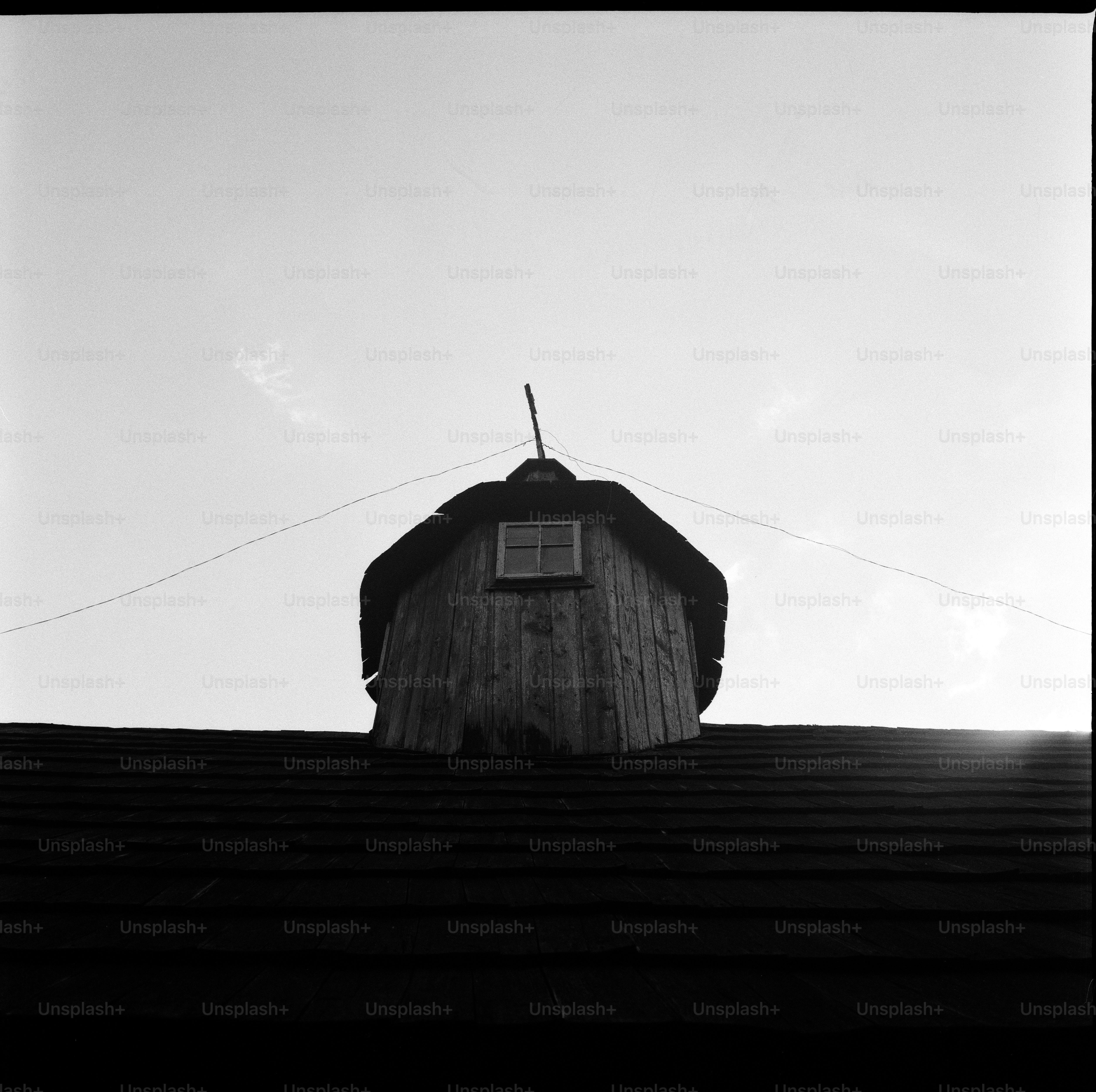 Wooden attic window on shingled roof - Photo on Unsplash+