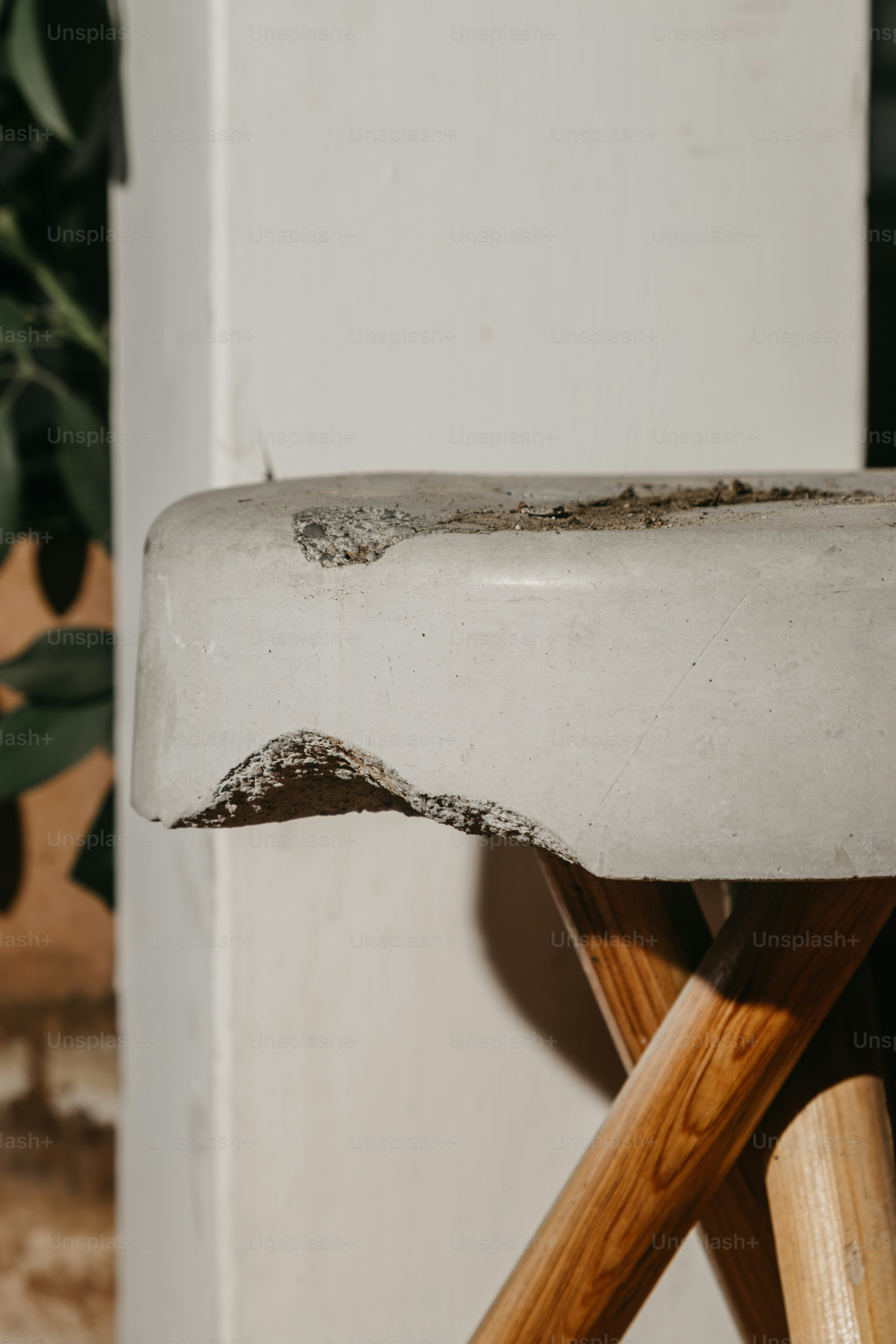 Wooden plank against concrete block - Photo on Unsplash+
