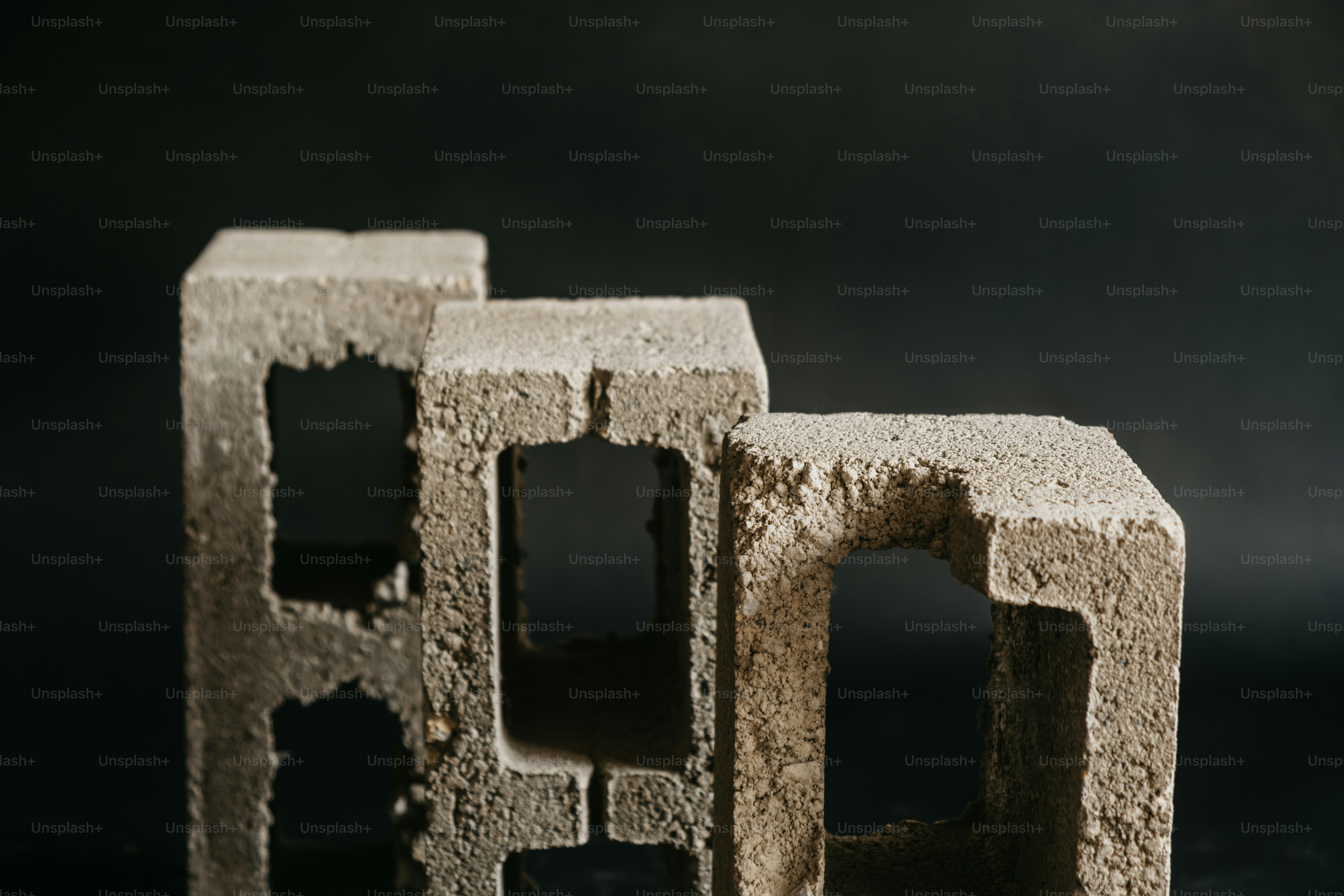 Three rough concrete blocks - Photo on Unsplash+