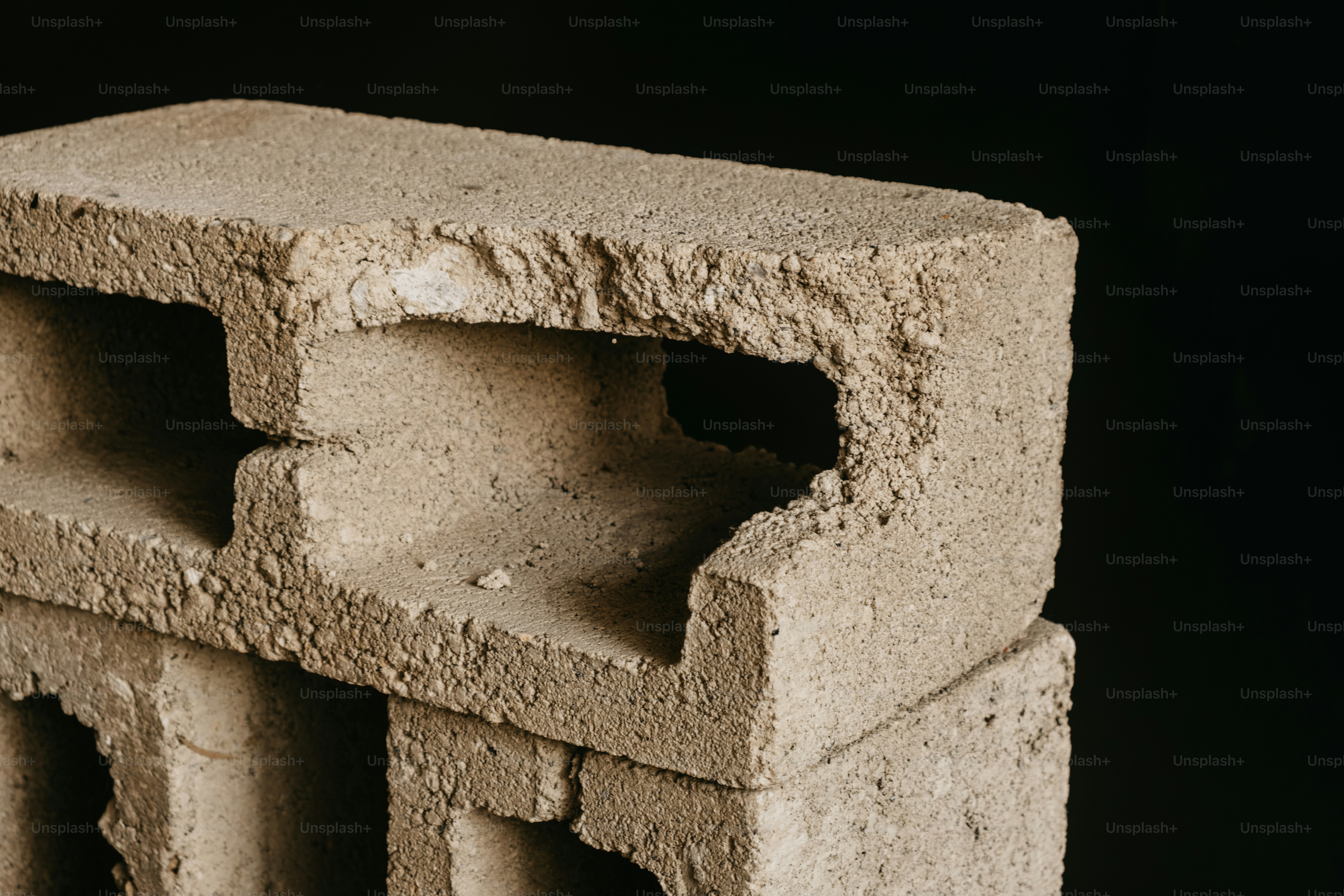 Rough concrete block with hollow openings - Photo on Unsplash+