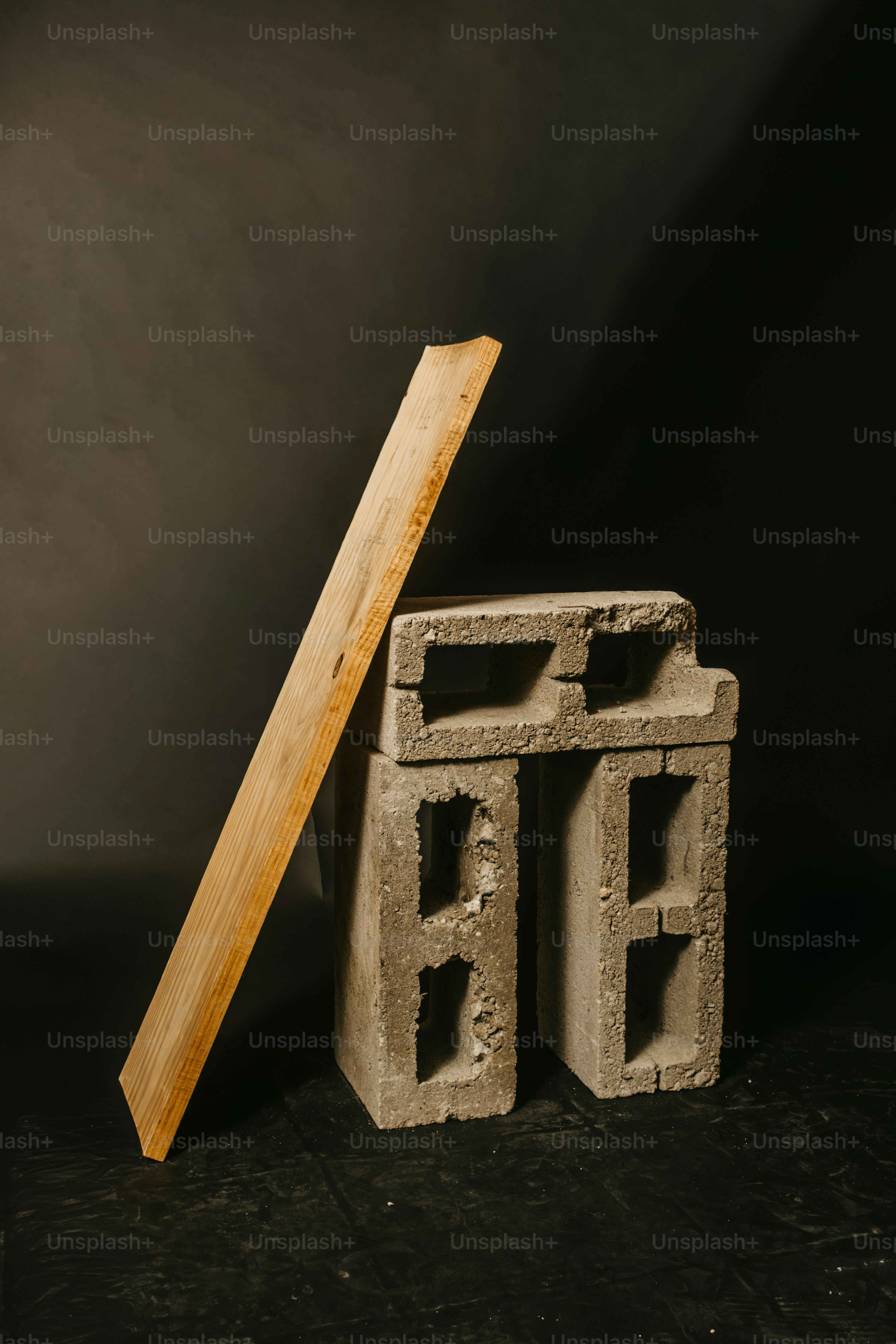 Wooden plank leaning on concrete blocks - Photo on Unsplash+