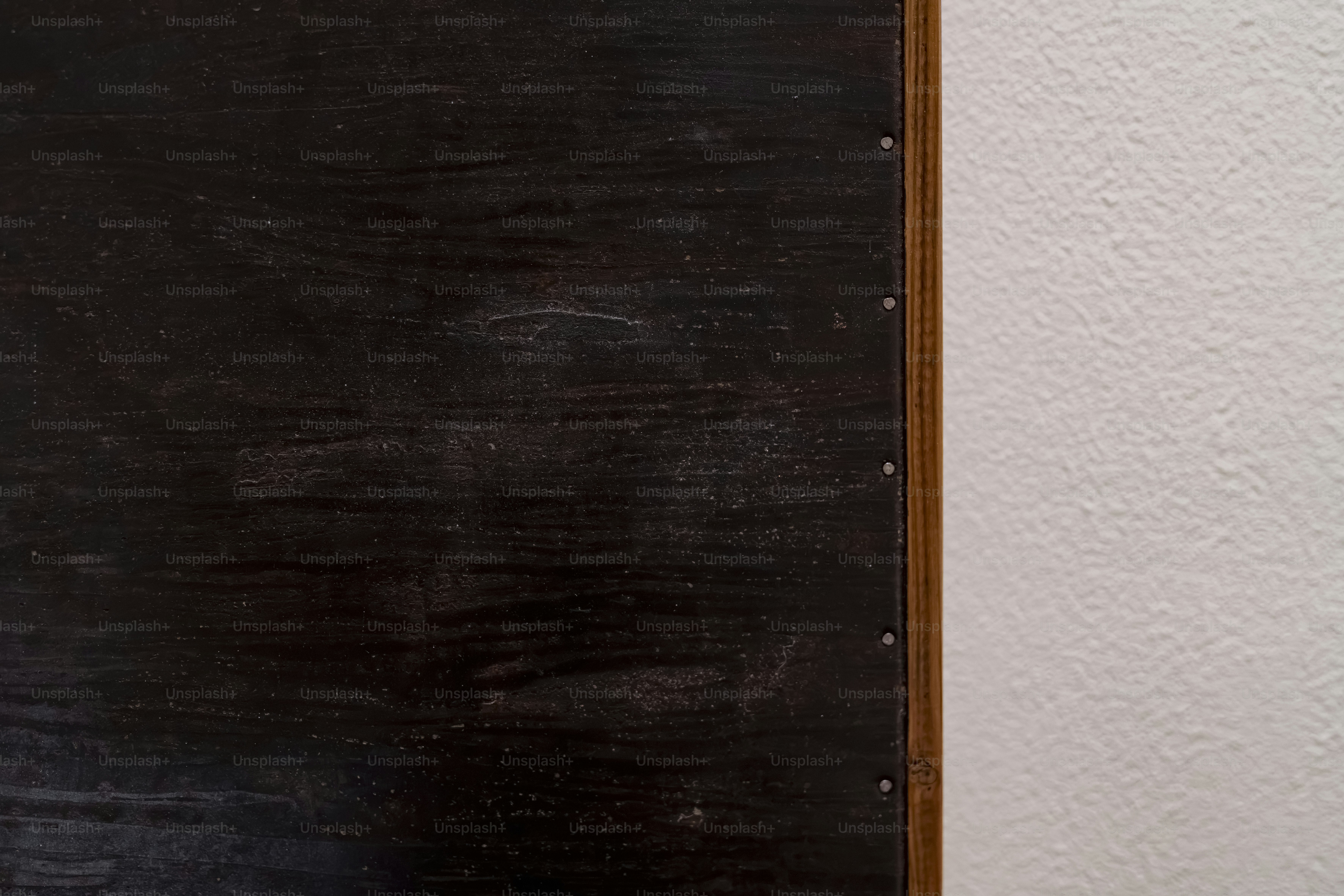 Dark metal panel with rivets - Photo on Unsplash+