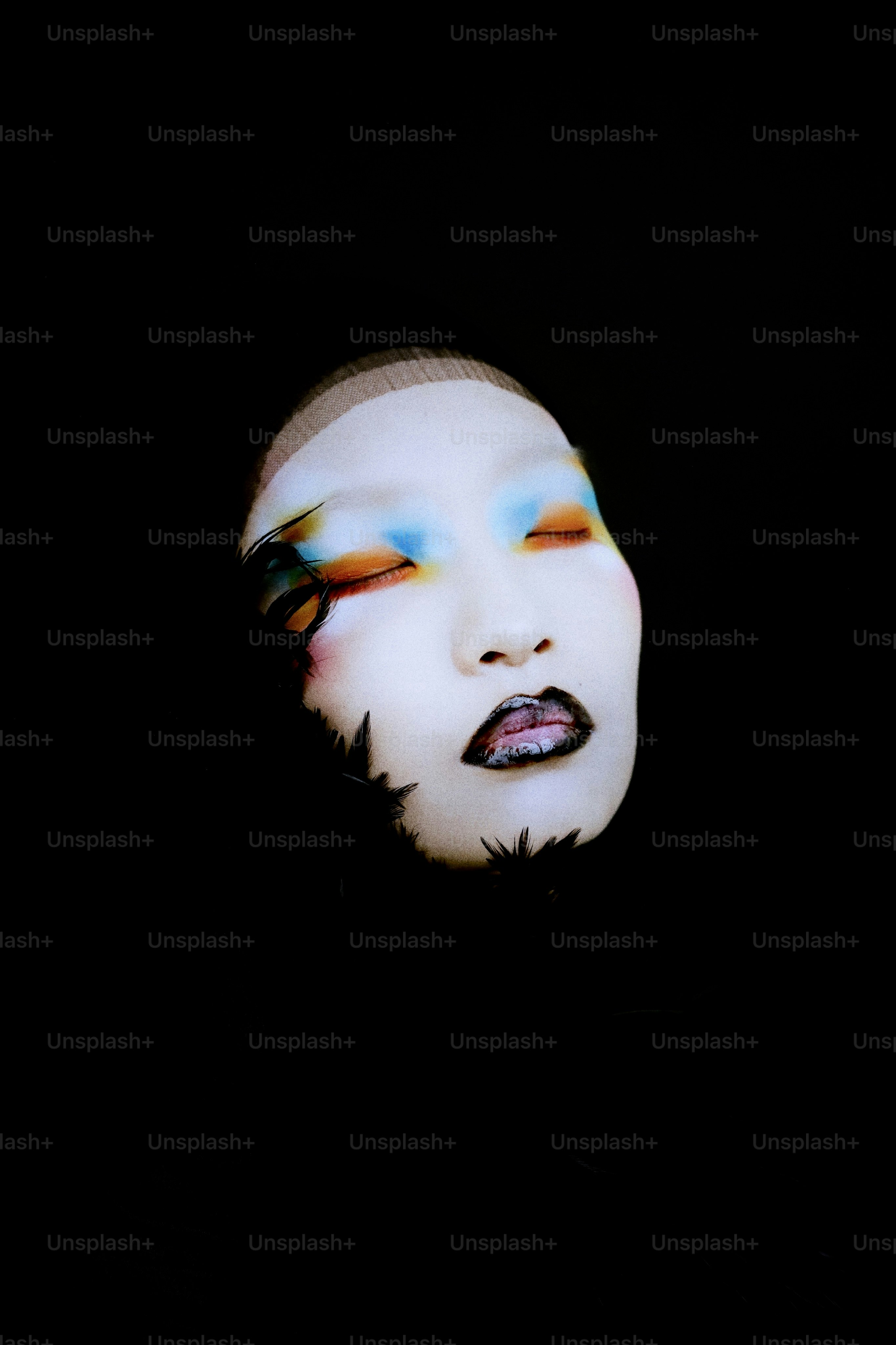 Person with colorful makeup and feathers - Photo on Unsplash+