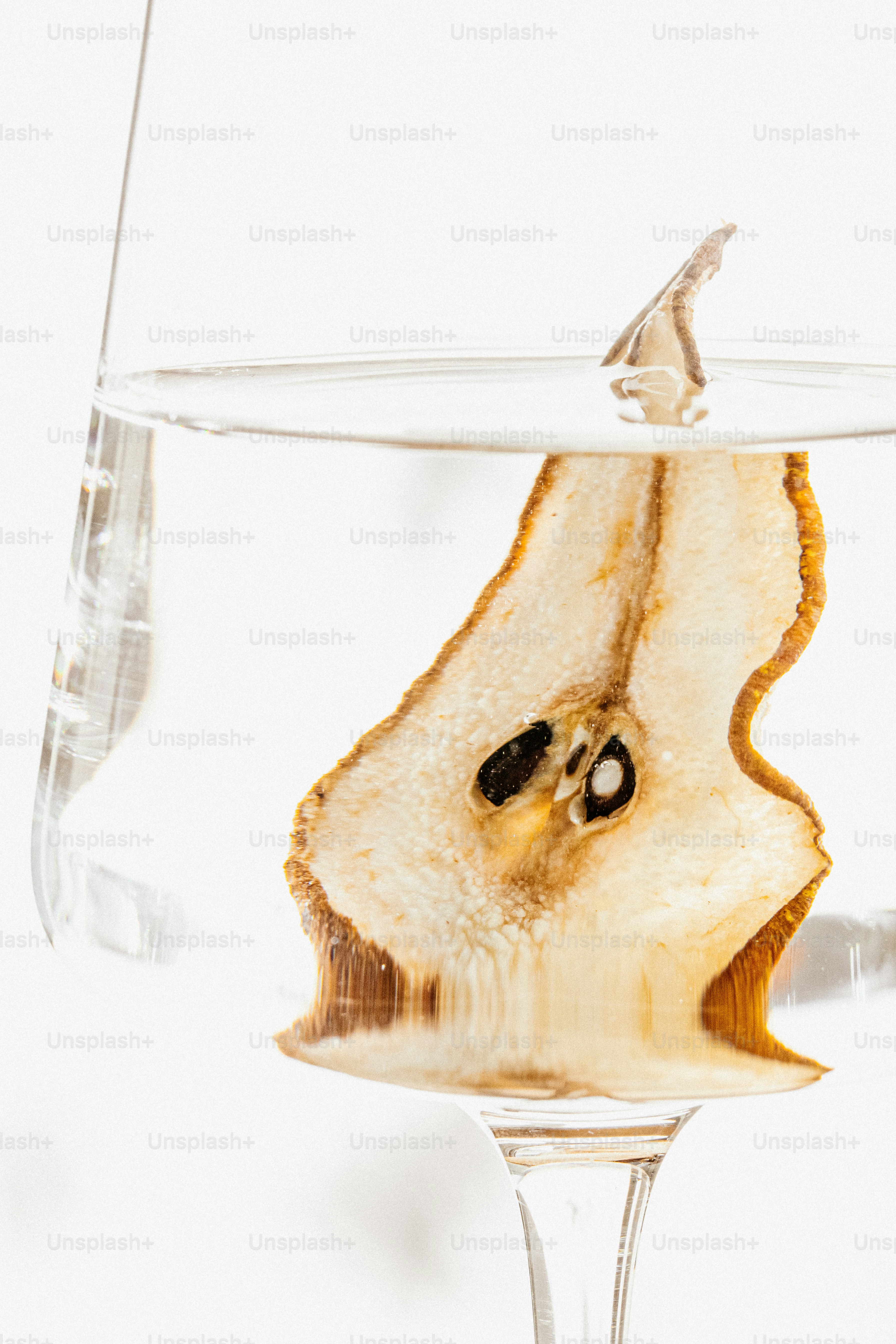 Dried pear slice in water glass - Photo on Unsplash+