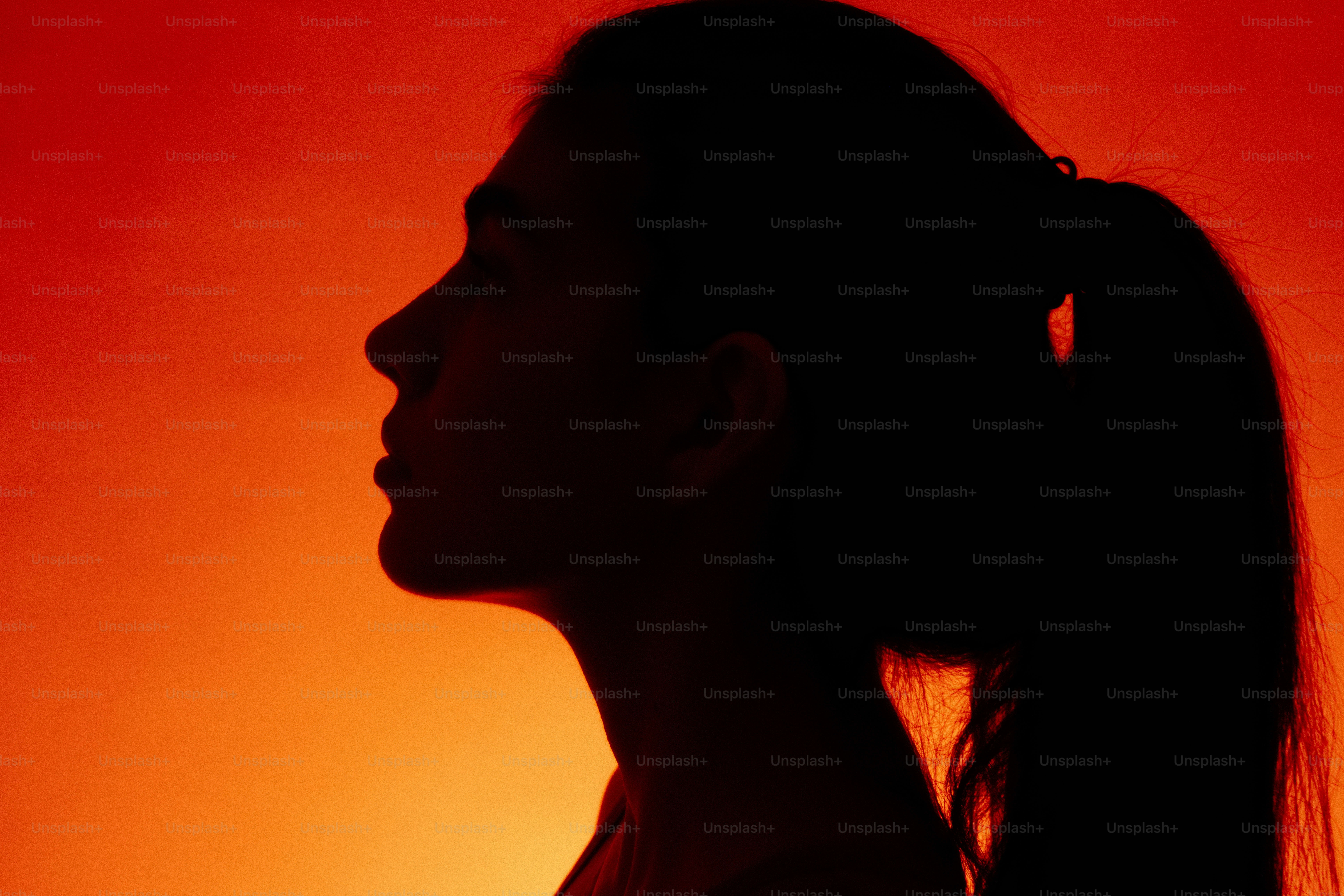 Woman silhouette against orange background - Photo on Unsplash+