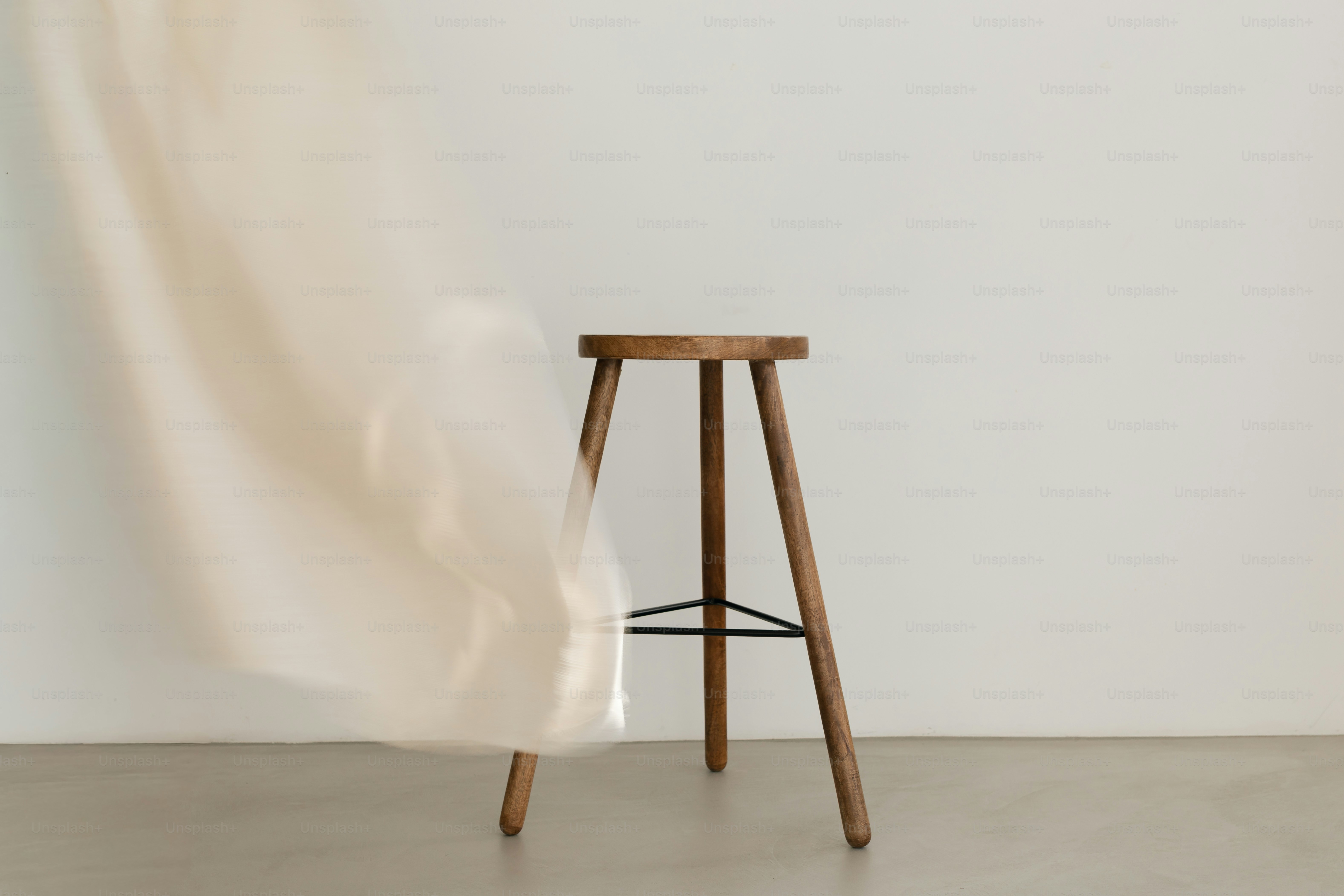 Wooden stool with flowing curtain - Photo on Unsplash+