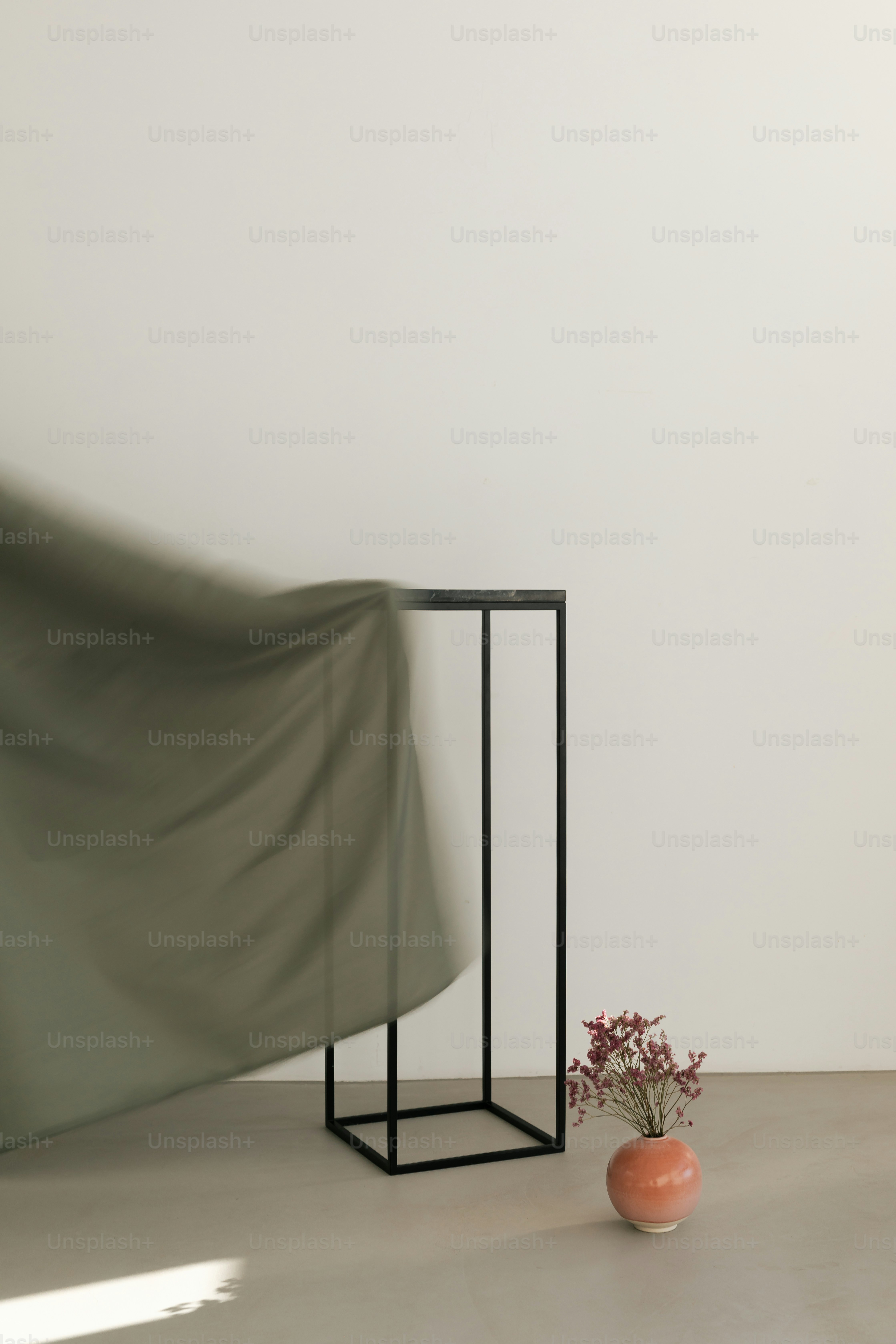 Green fabric blowing near metal pedestal - Photo on Unsplash+