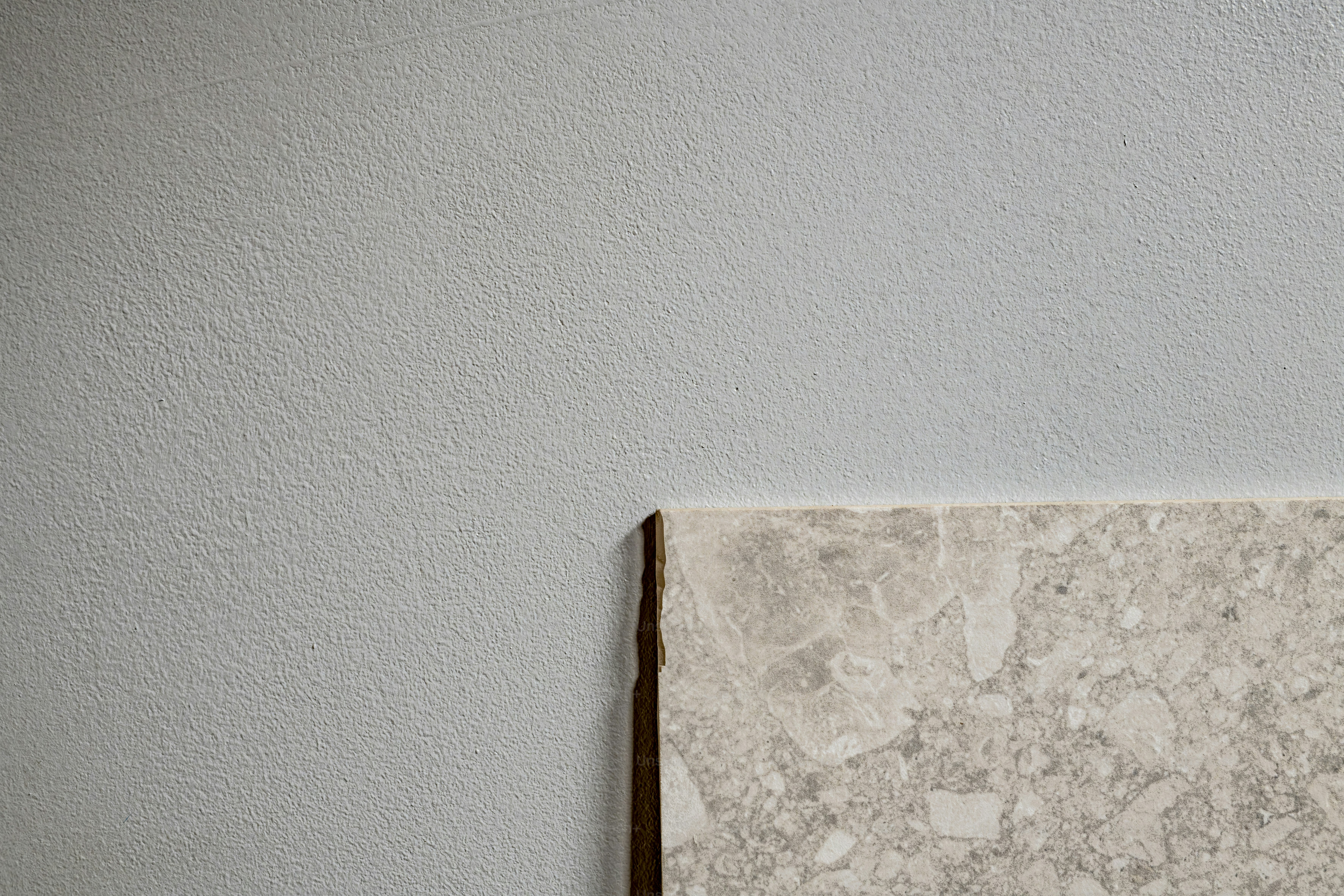 Layered wooden planks against concrete wall - Photo on Unsplash+