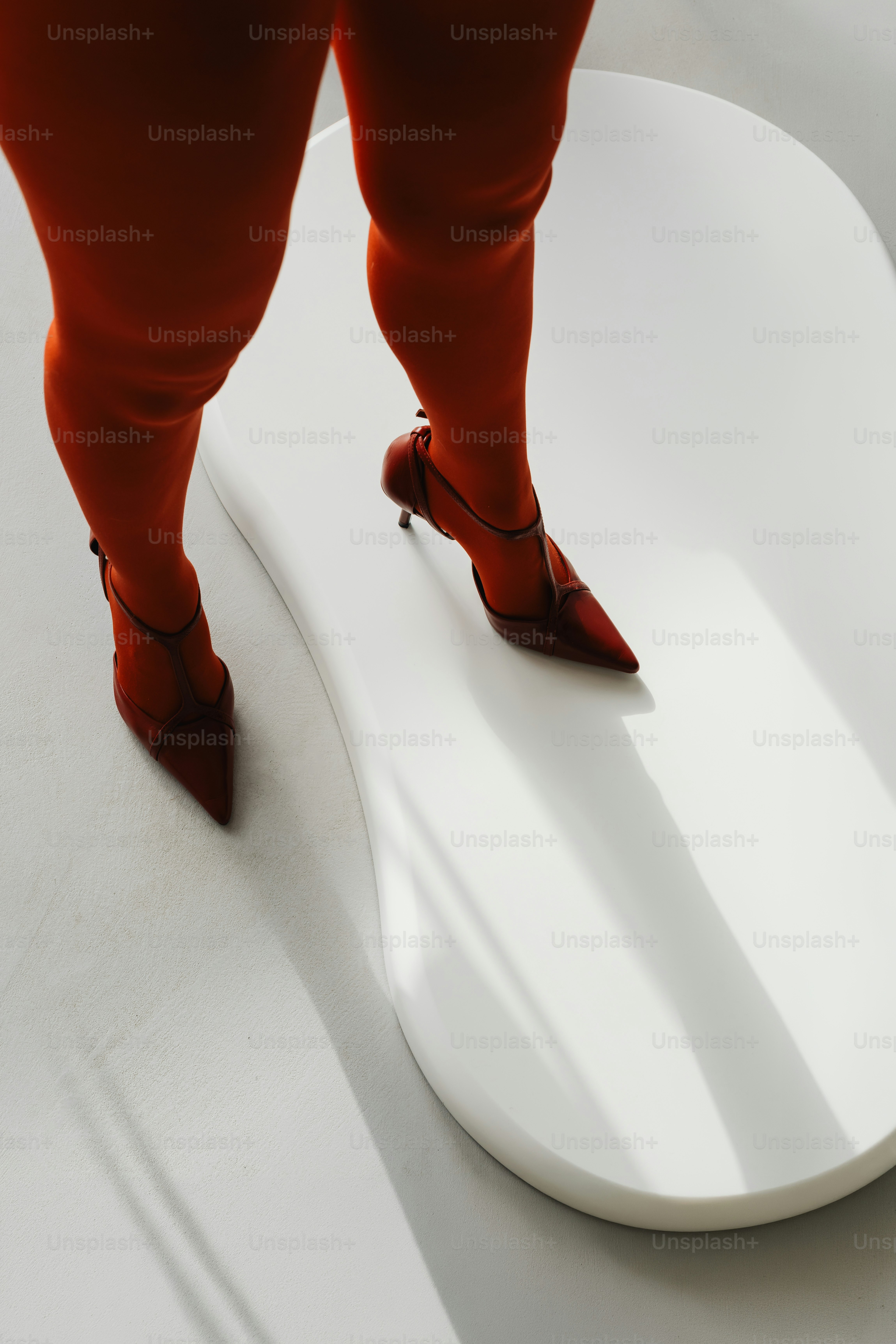 Leg in orange tights and heel - Photo on Unsplash+