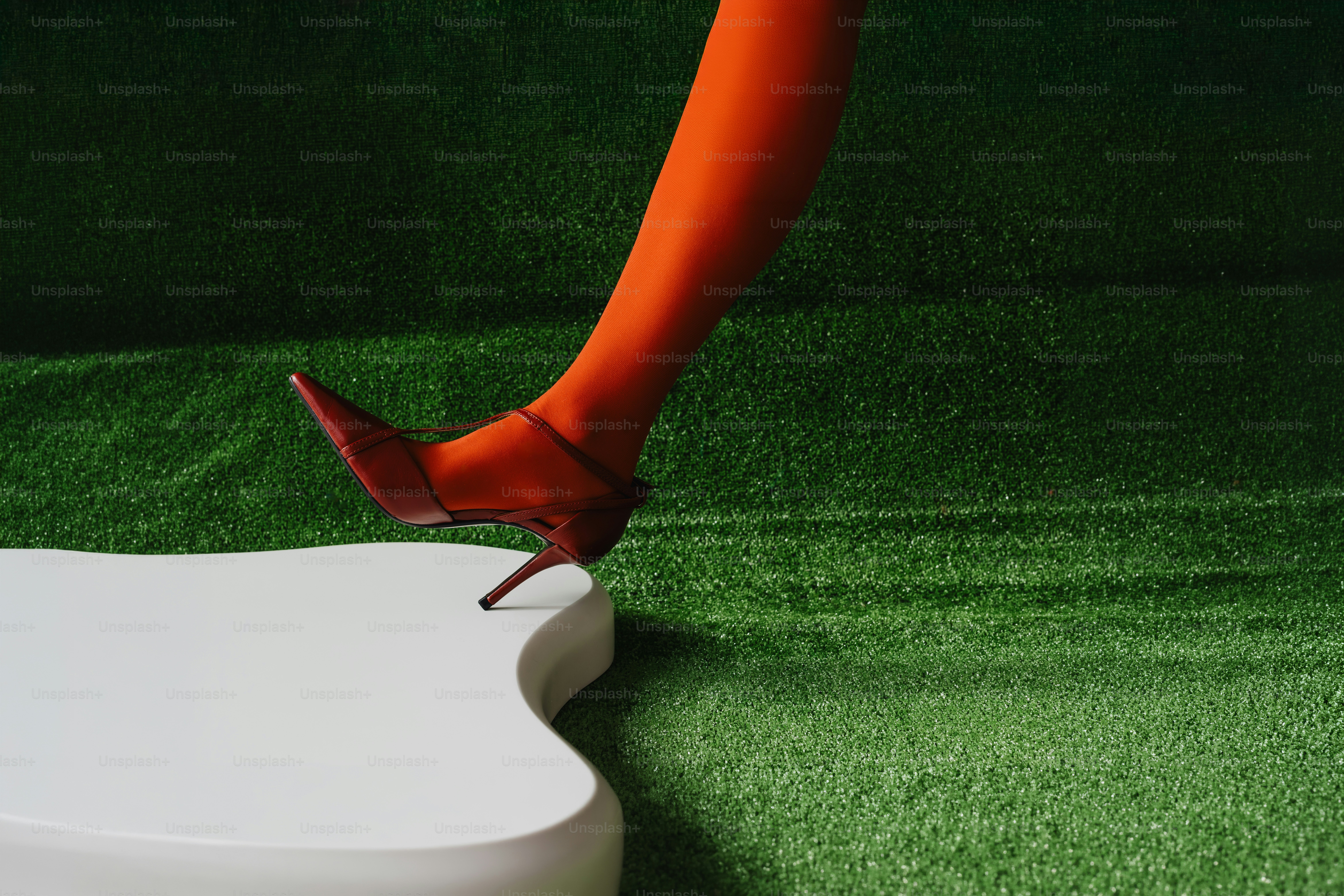 Leg in orange tights and heel - Photo on Unsplash+
